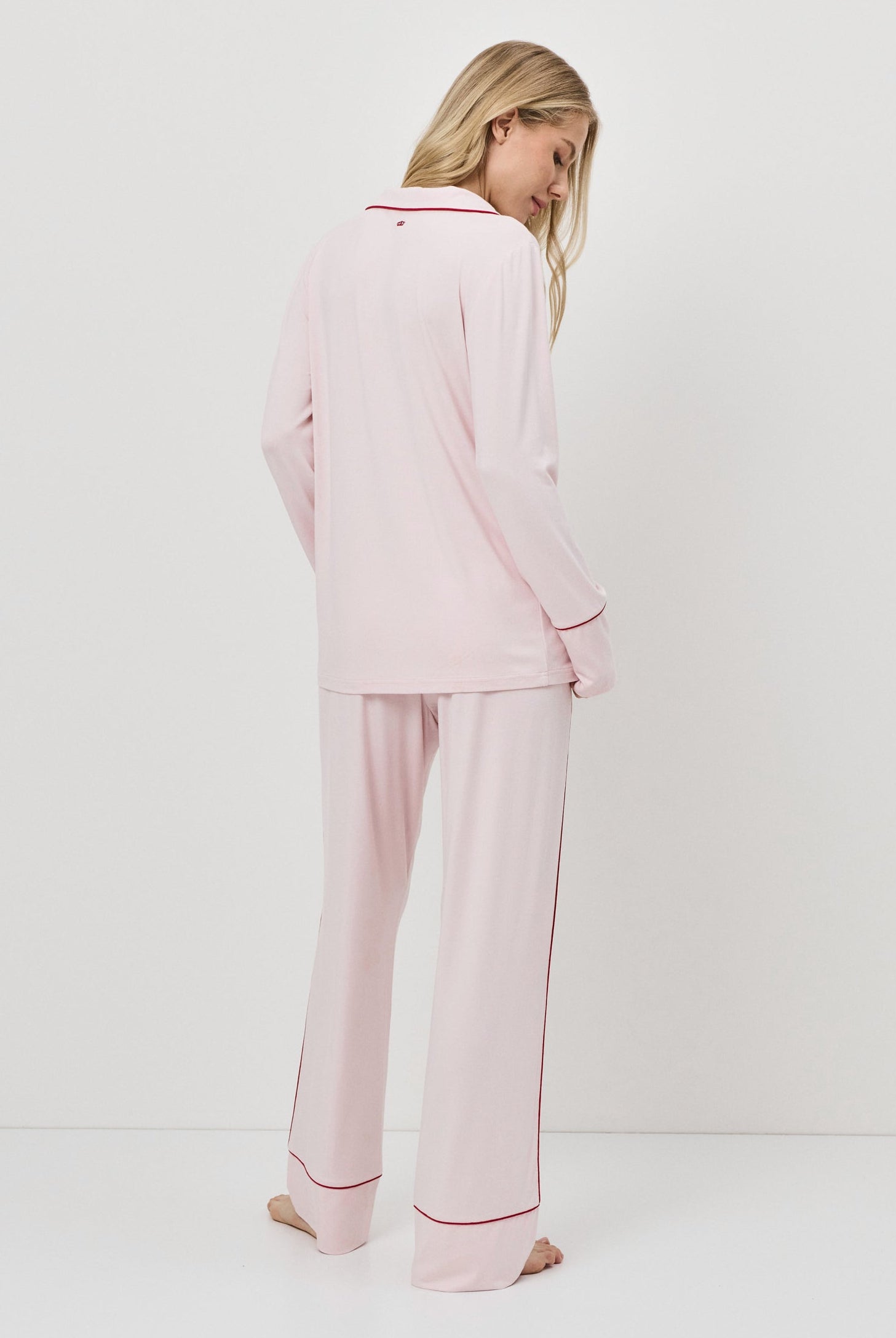 Woman wearing pink pajamas with a white background