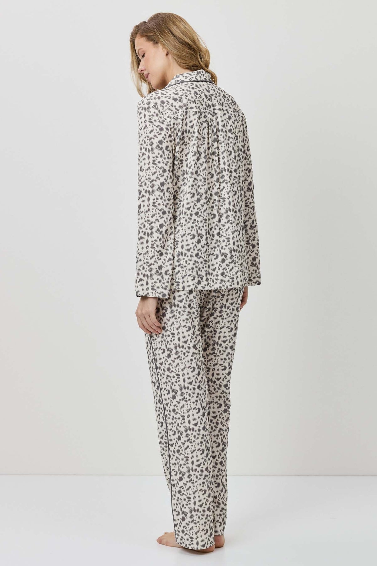 Person wearing a patterned pajama set on a white background