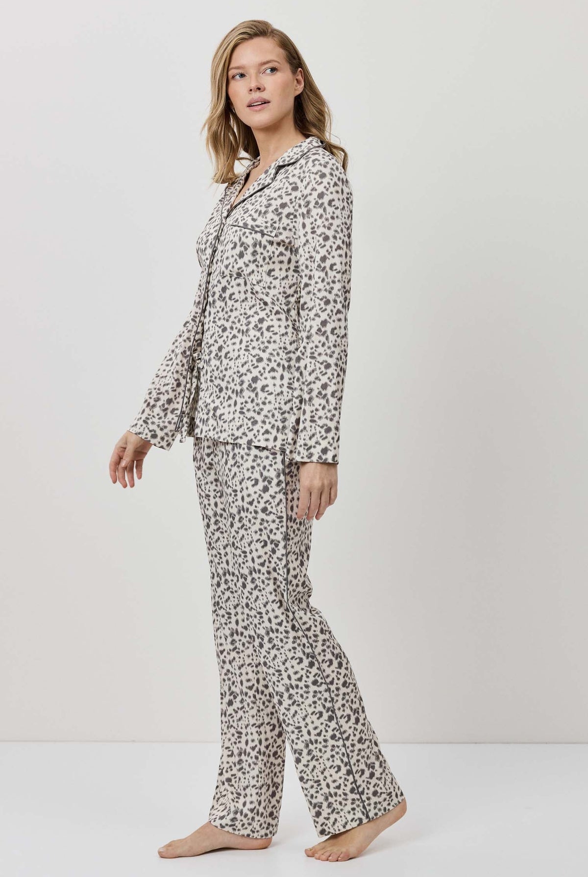 Woman wearing a floral pajama set on a white background