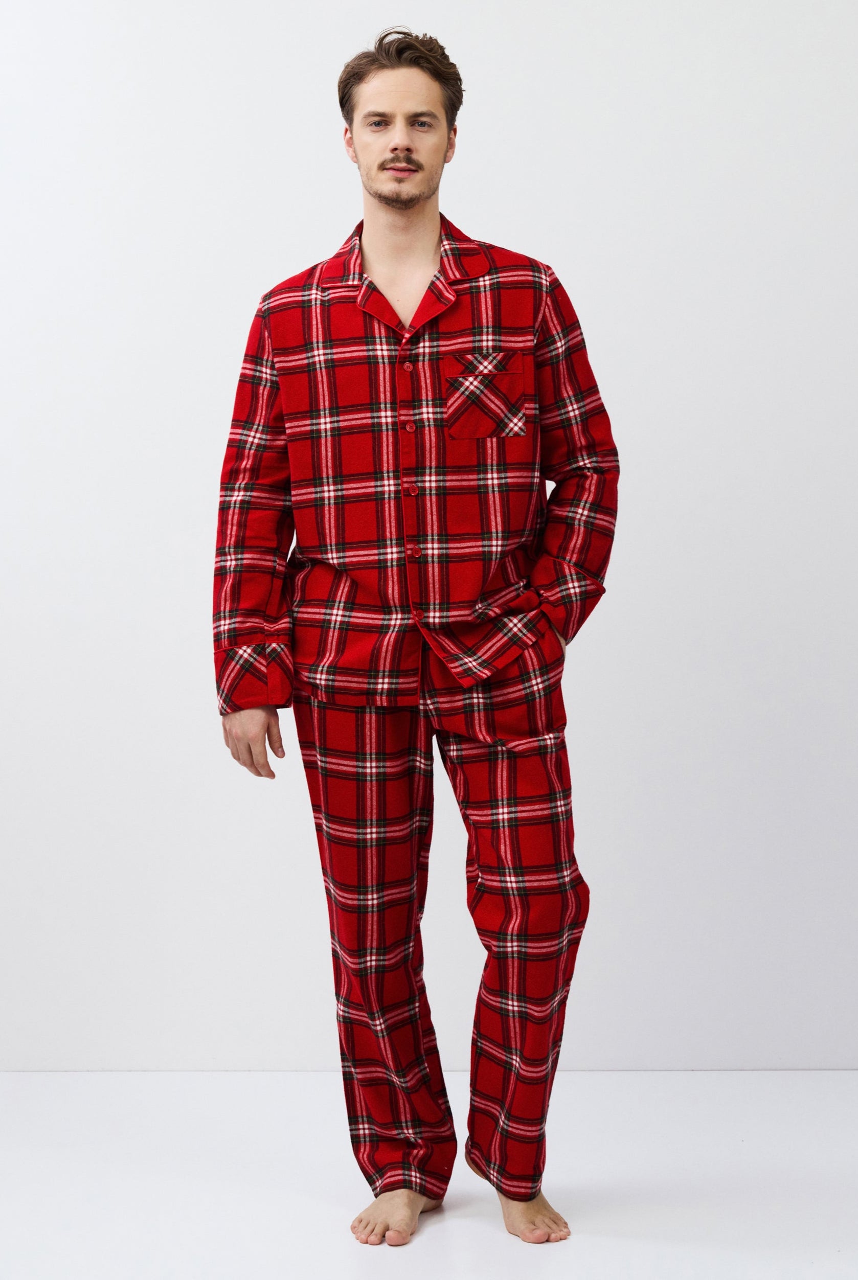 Man wearing red plaid pajamas on a white background