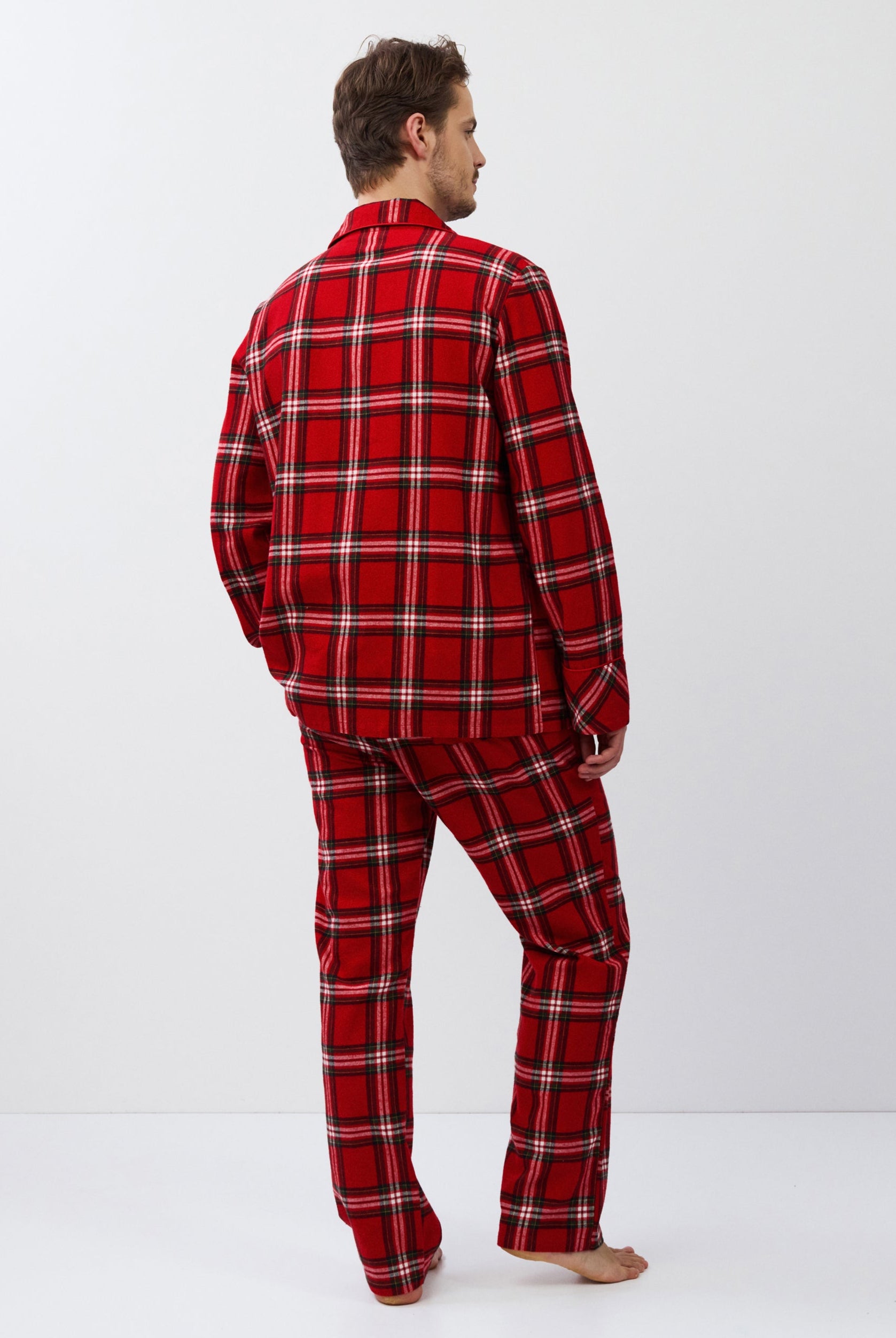 Man wearing red plaid pajamas on a white background
