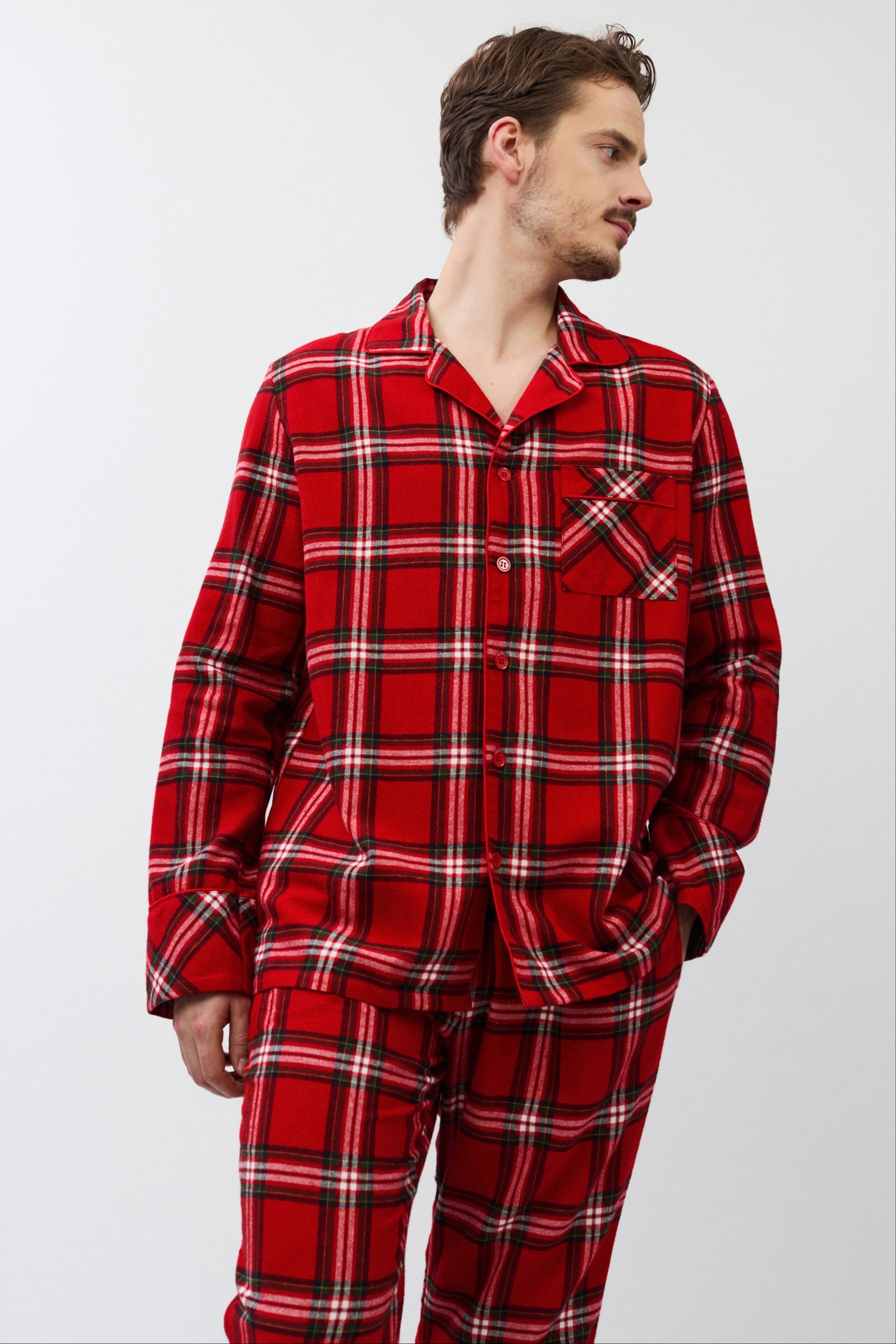 Man wearing red plaid pajamas on a white background