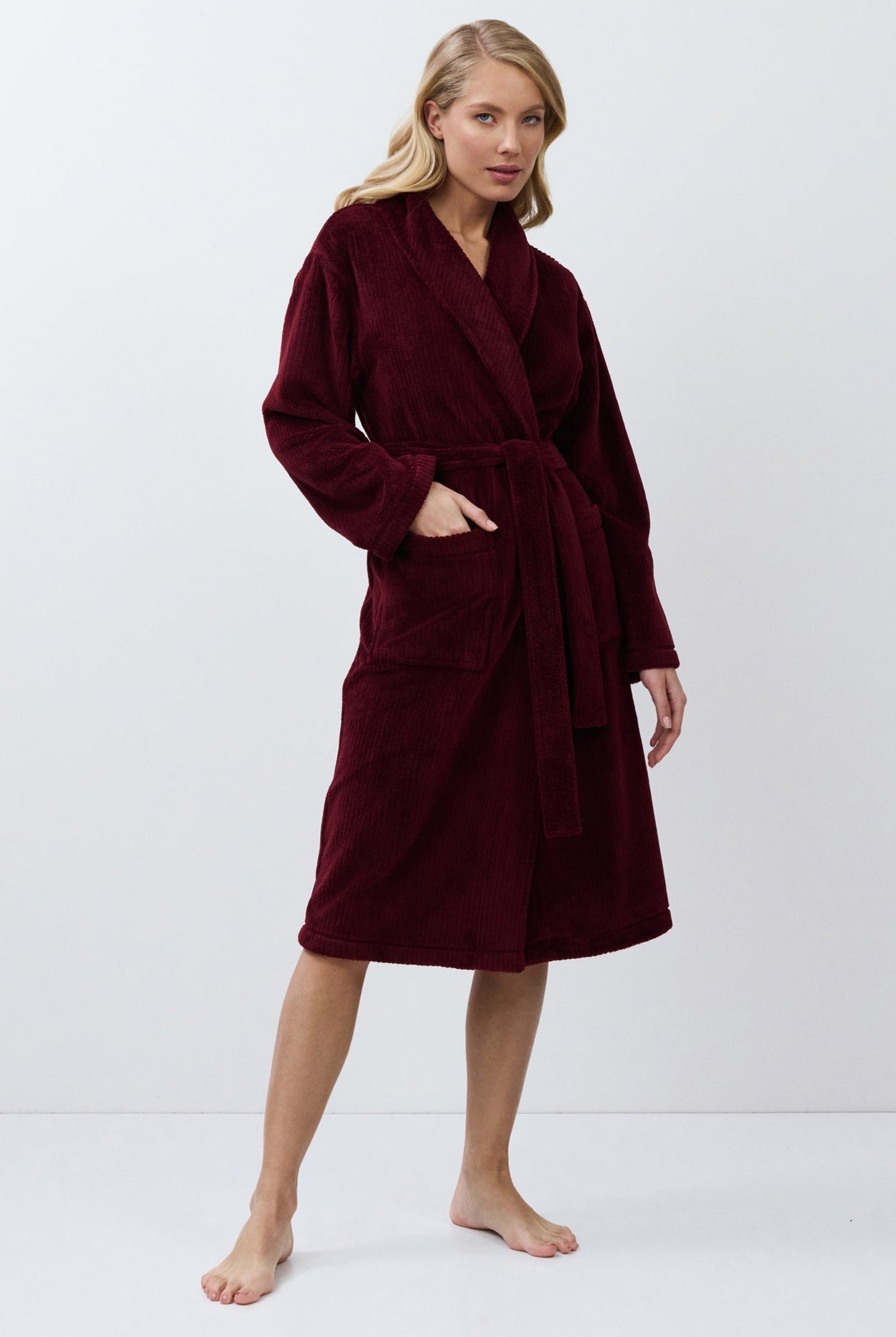 Woman wearing a burgundy robe on a white background