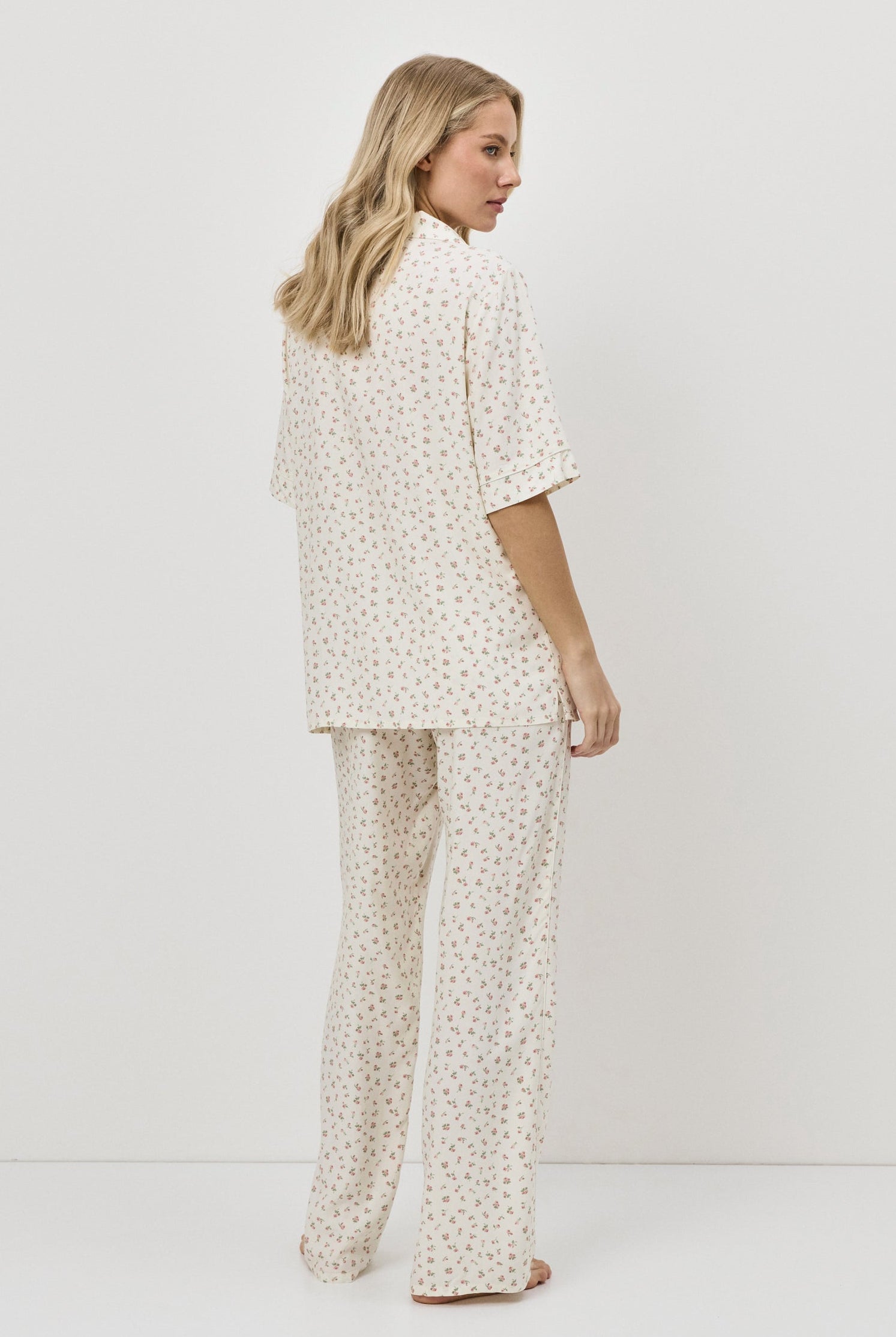 Woman wearing a pajama set against a white background