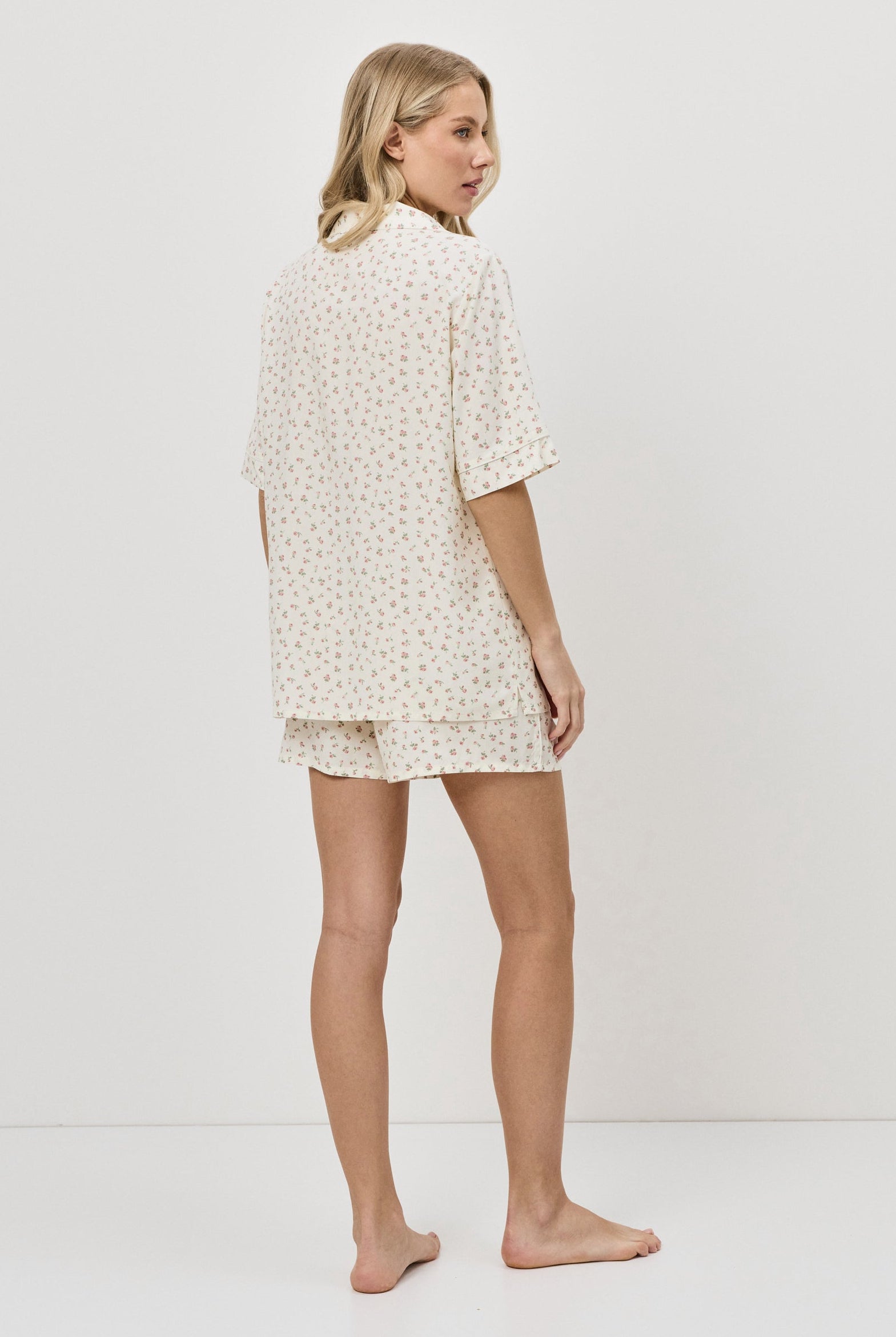 Woman wearing a pajama set on a white background