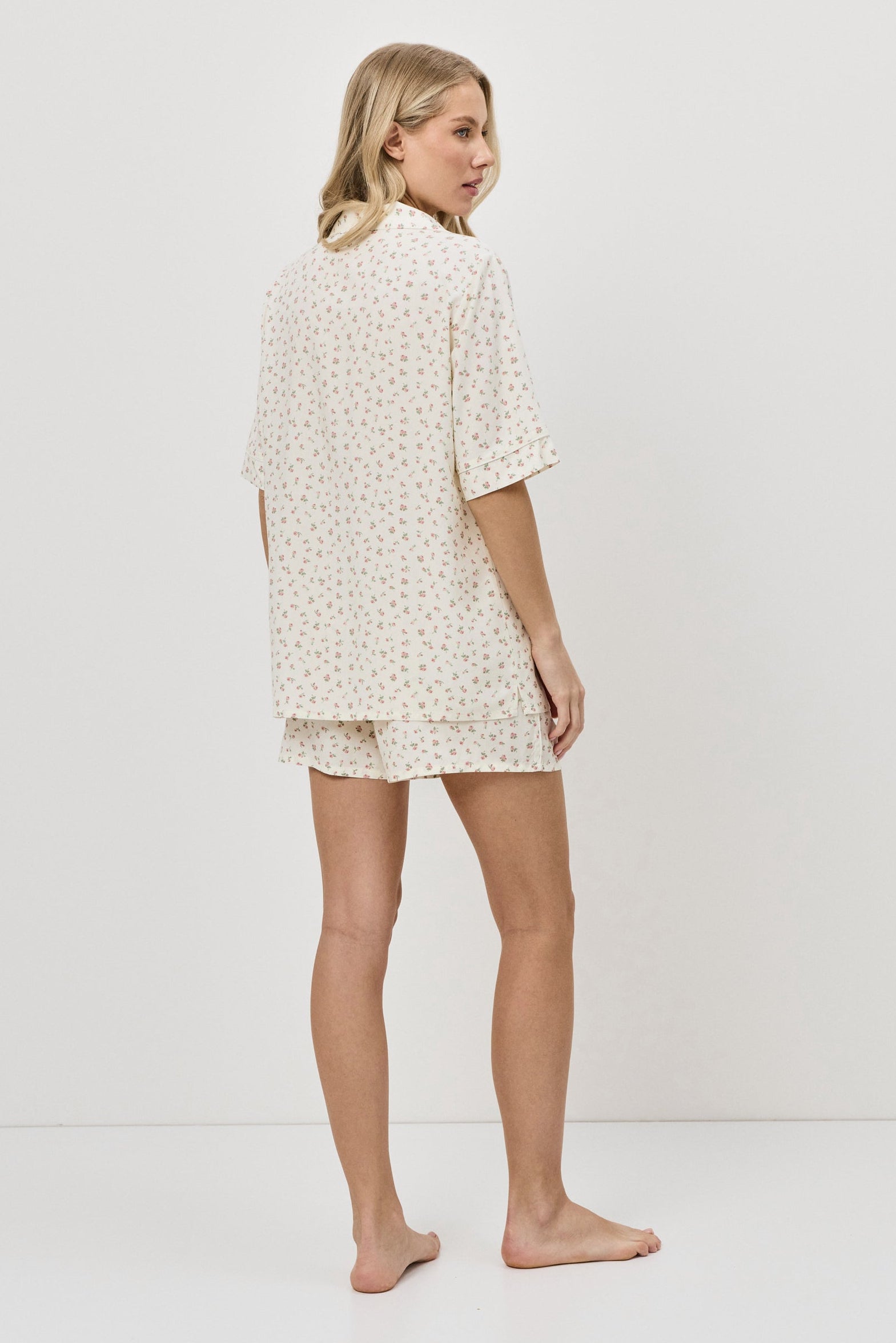 Woman wearing a pajama set on a white background