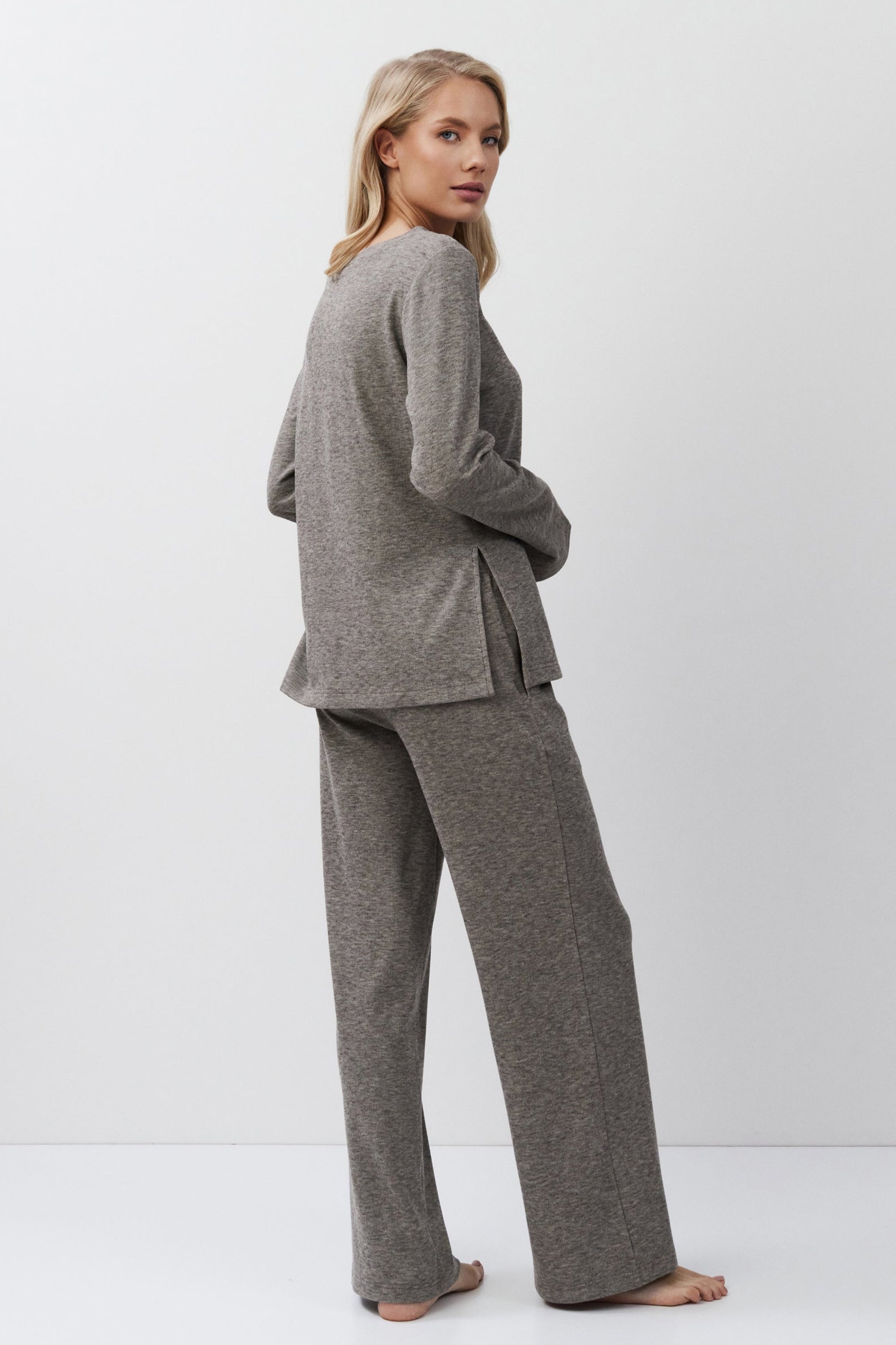 Woman wearing a brown outfit on a white background