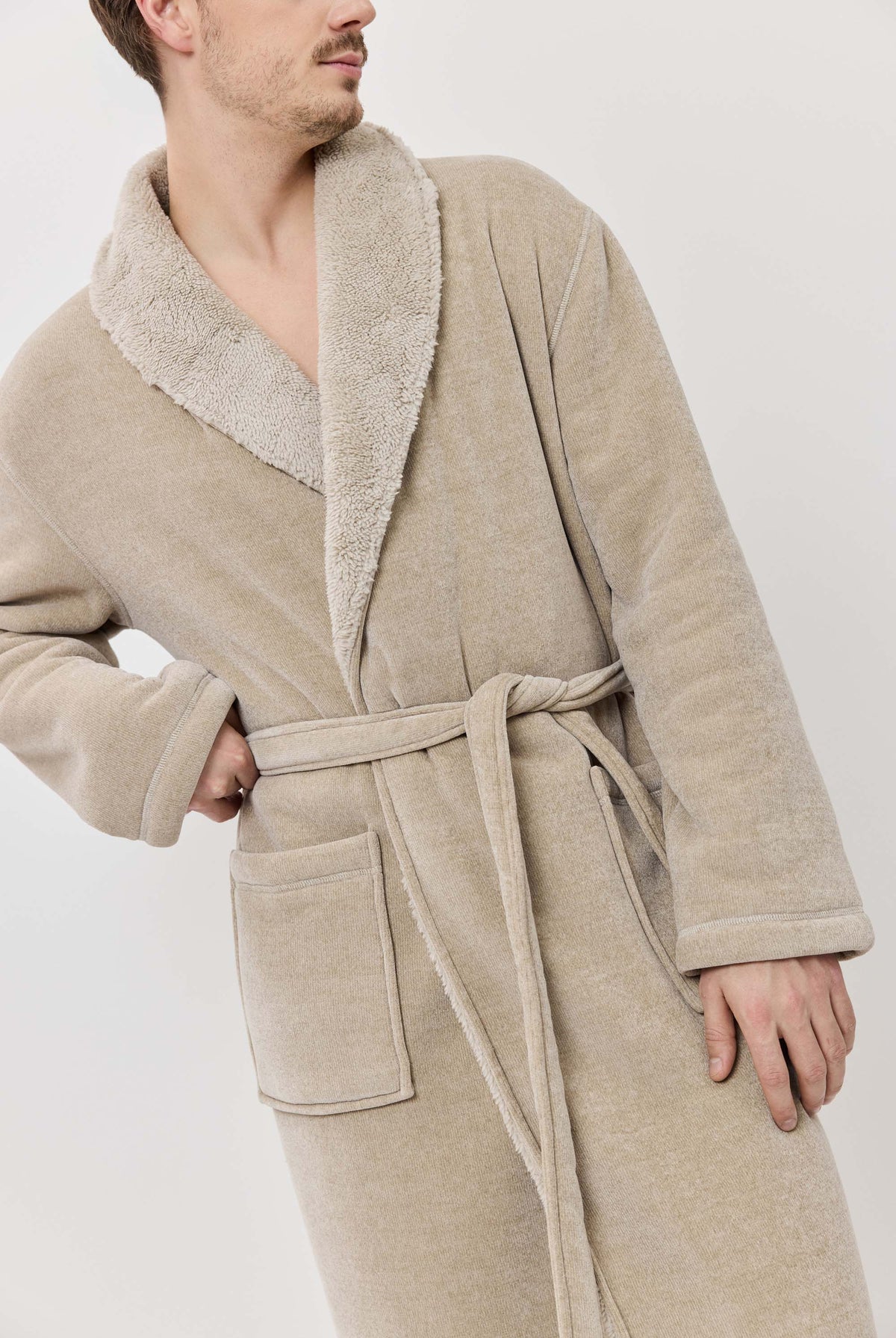 Man wearing a beige robe with a white background