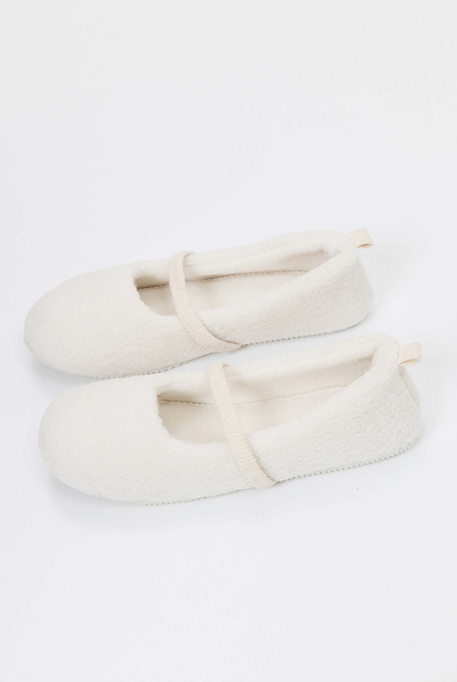 Pair of white slippers on a white background