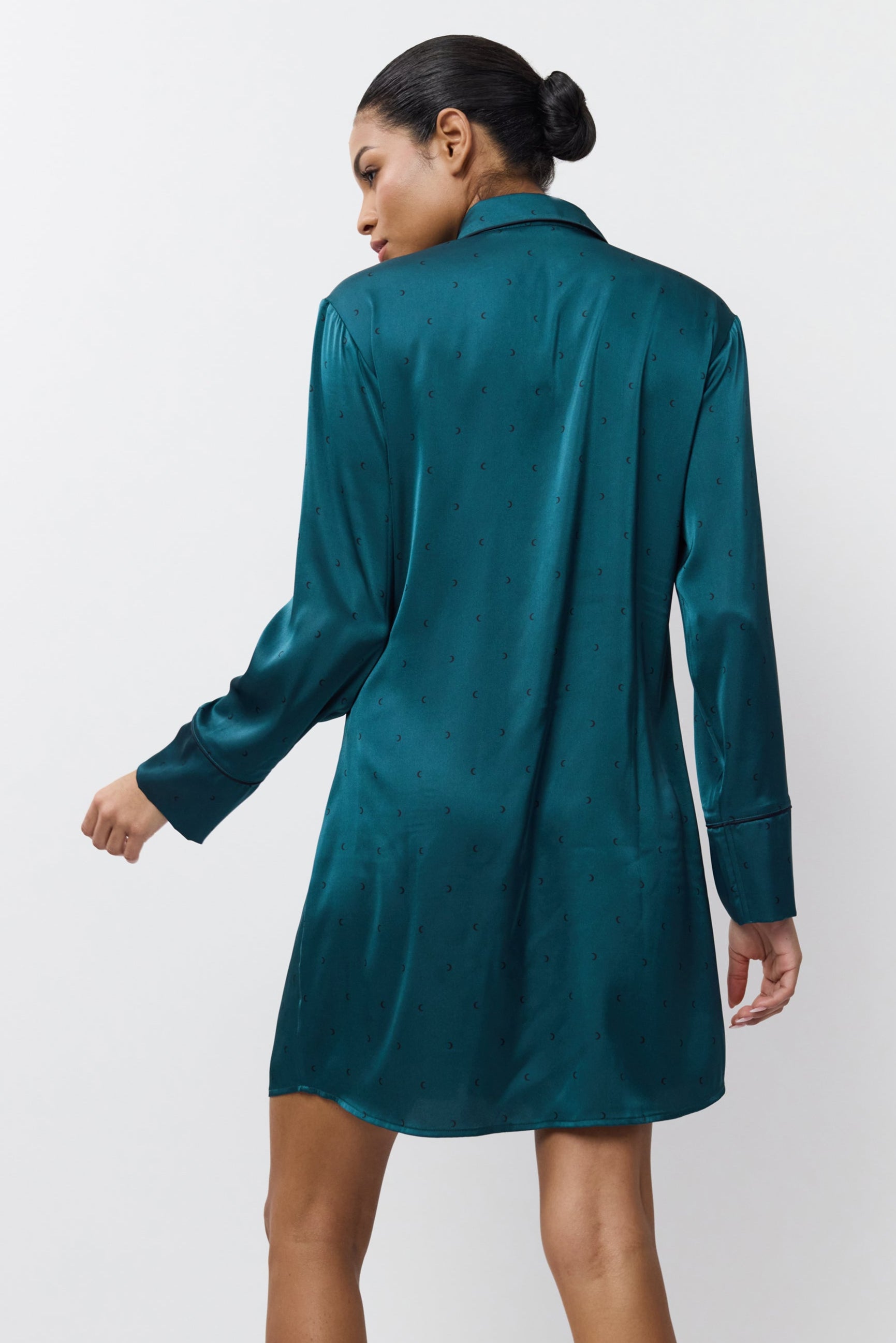 Woman wearing a satin nightdress against a white background