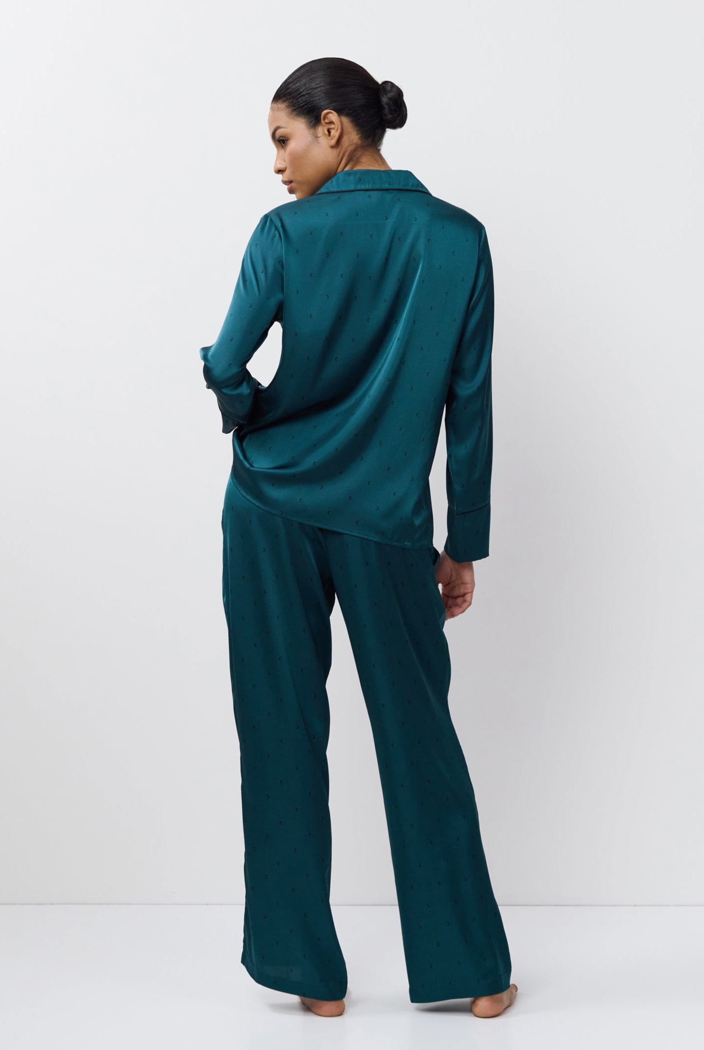 Woman wearing a pajama set on a white background