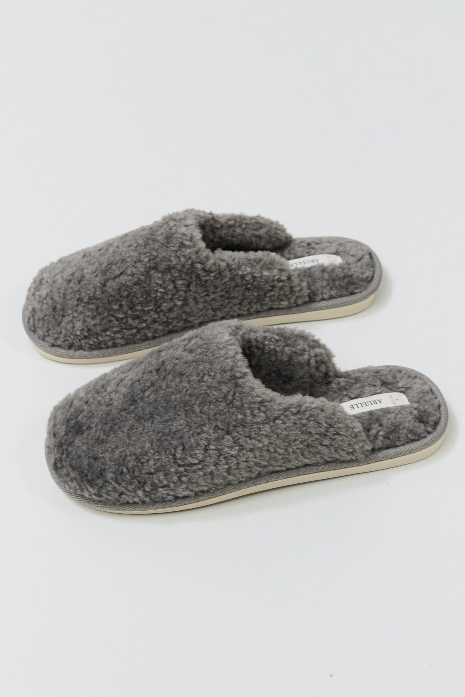Pair of gray slippers on a white background