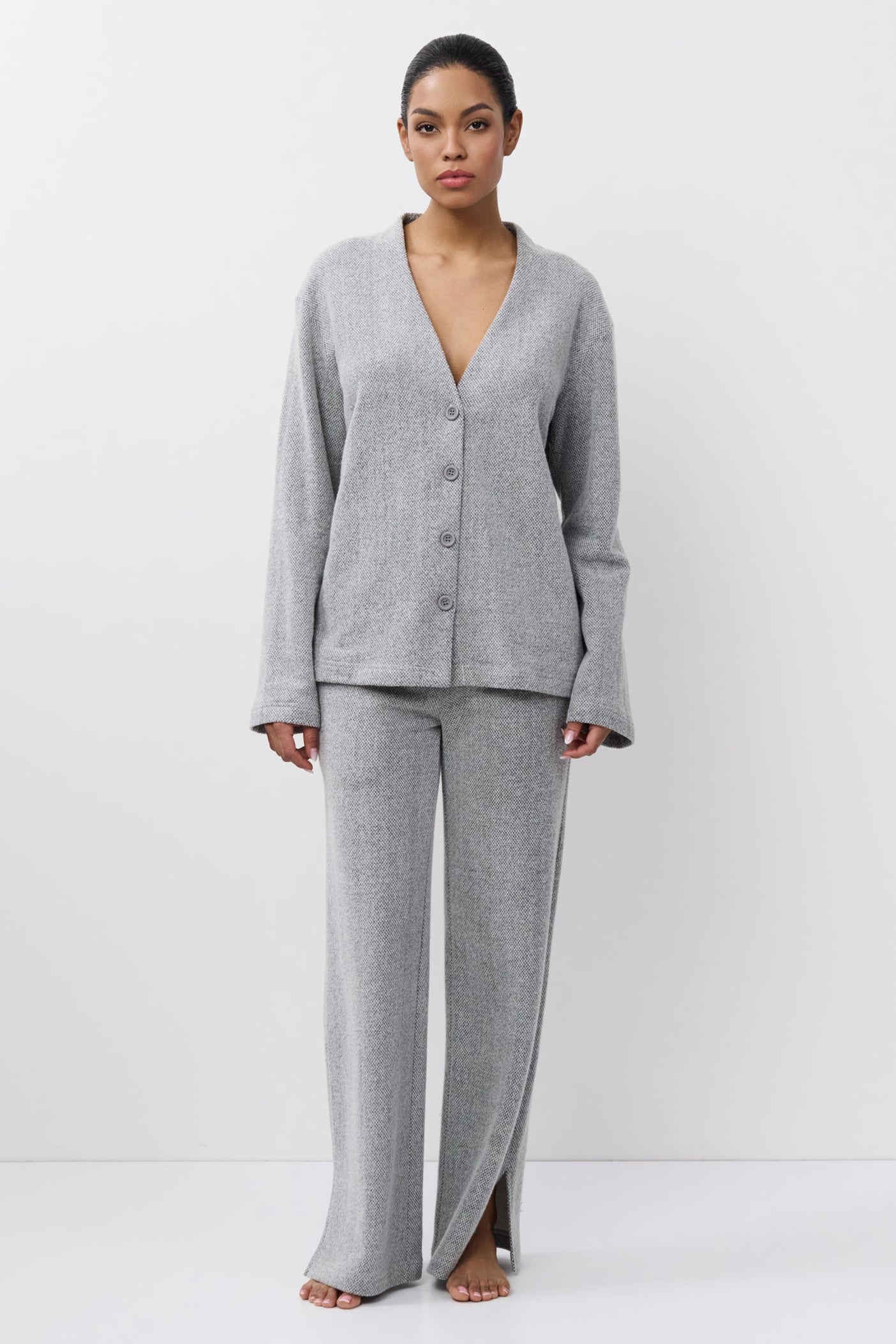 Woman wearing a gray set on a white background