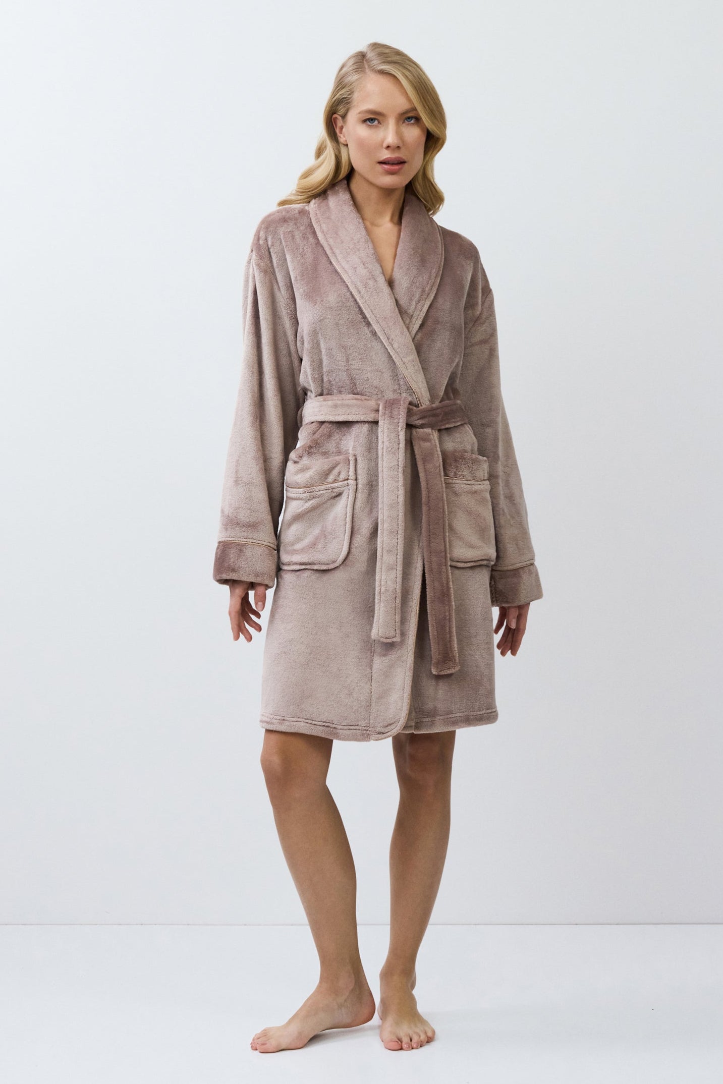 Woman wearing a choco bathrobe against a white background