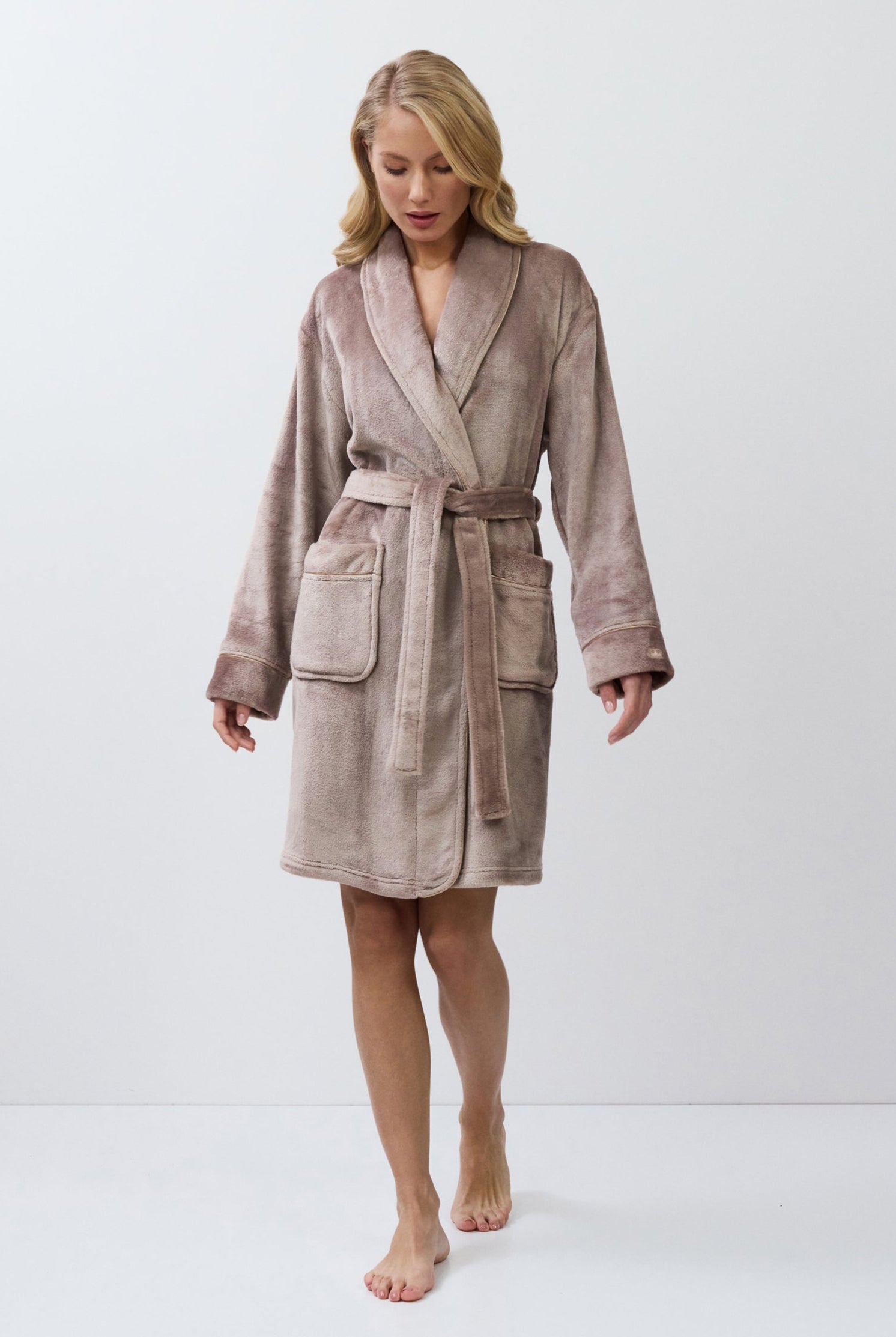 Woman wearing a choco bathrobe on a white background
