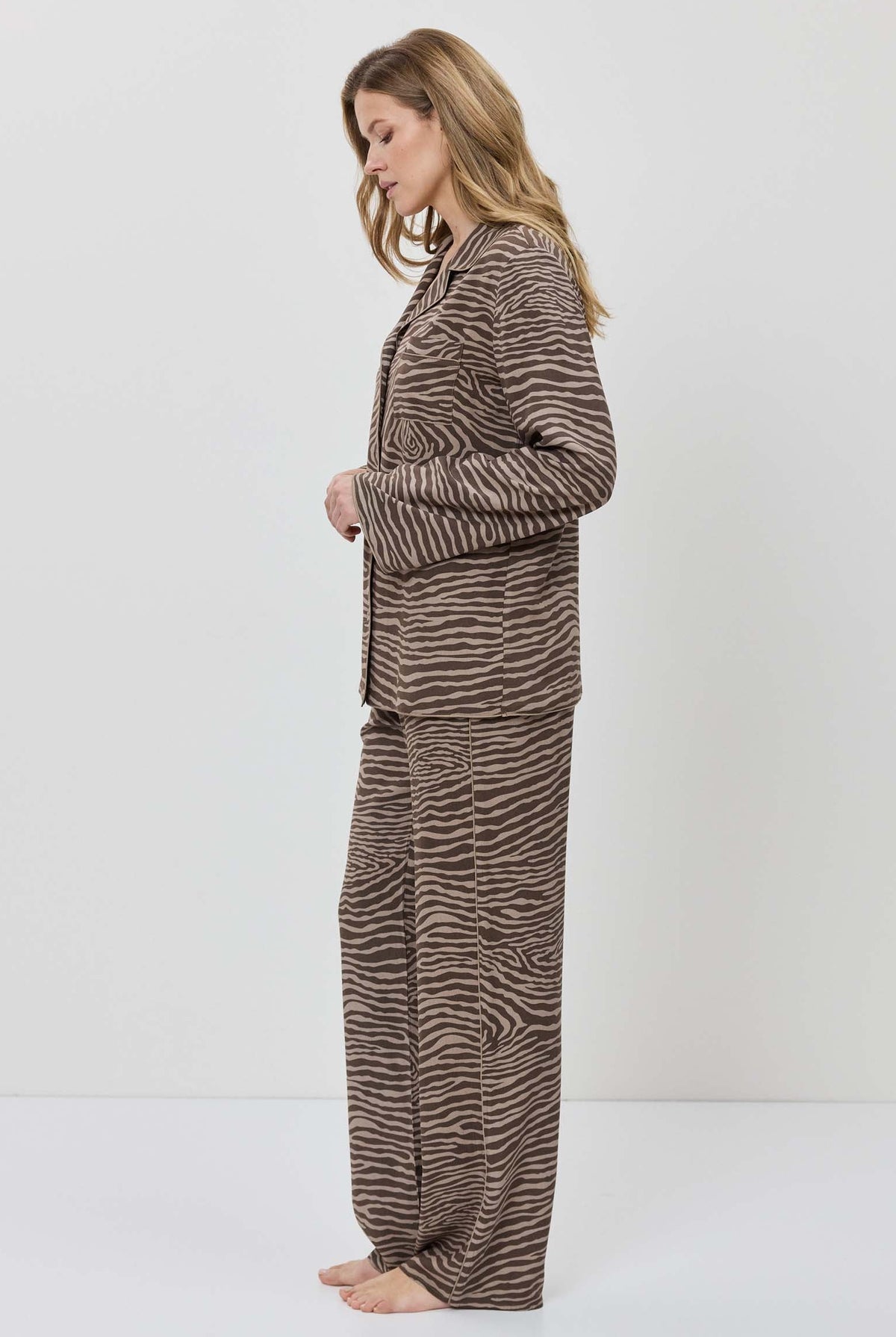 Woman wearing a zebra print outfit on a white background