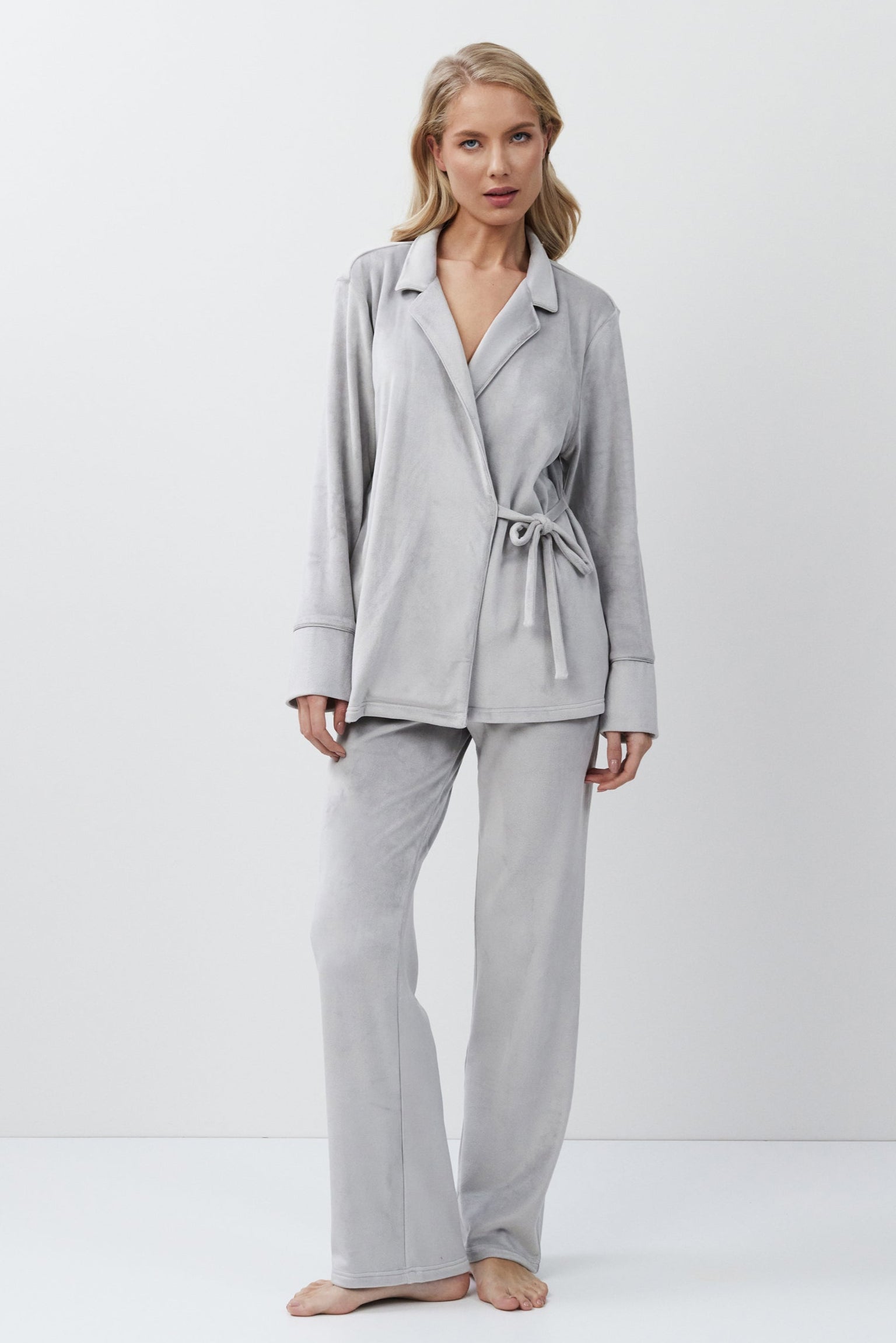 Woman wearing a gray set with a white background