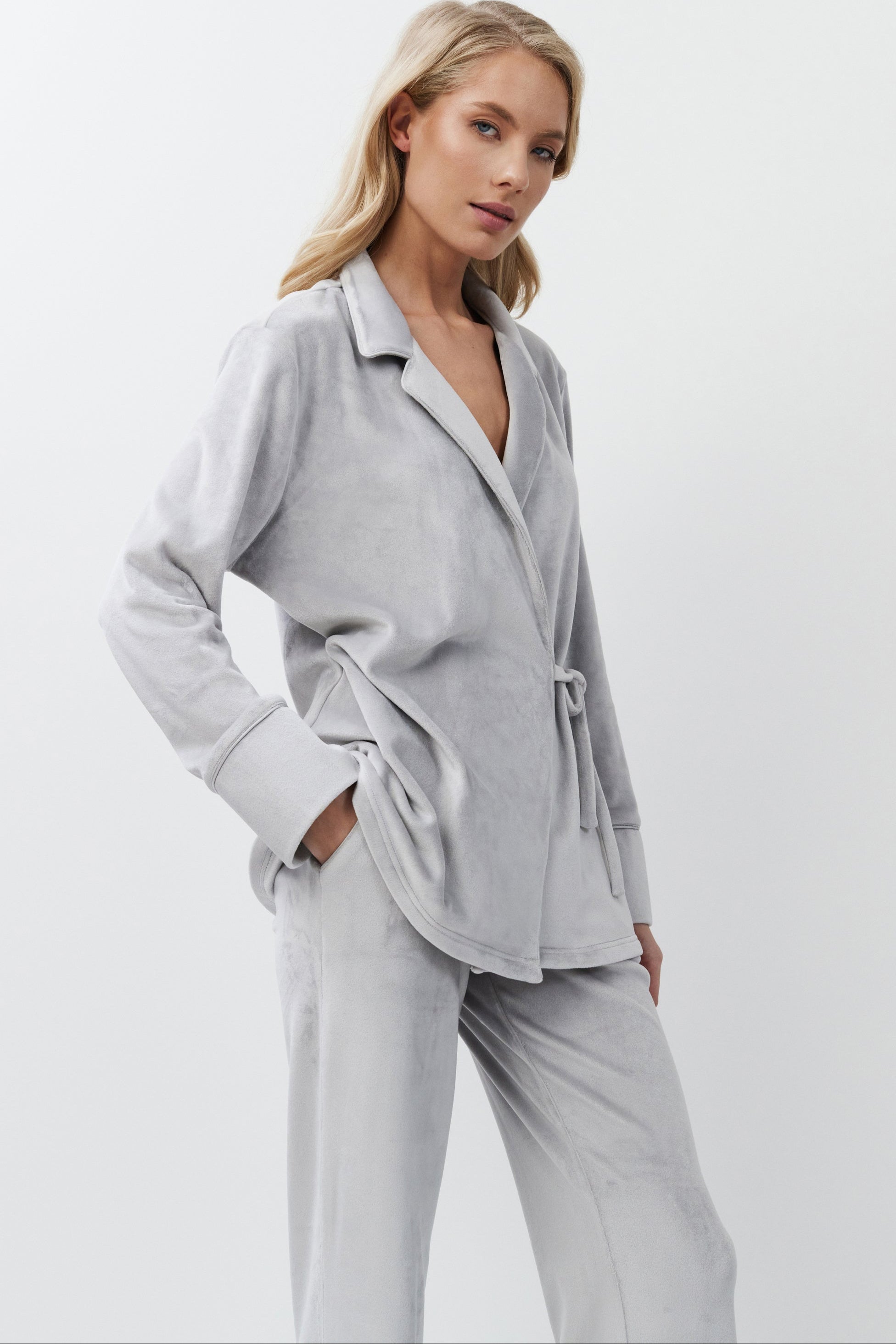 Woman wearing a light gray set on a white background