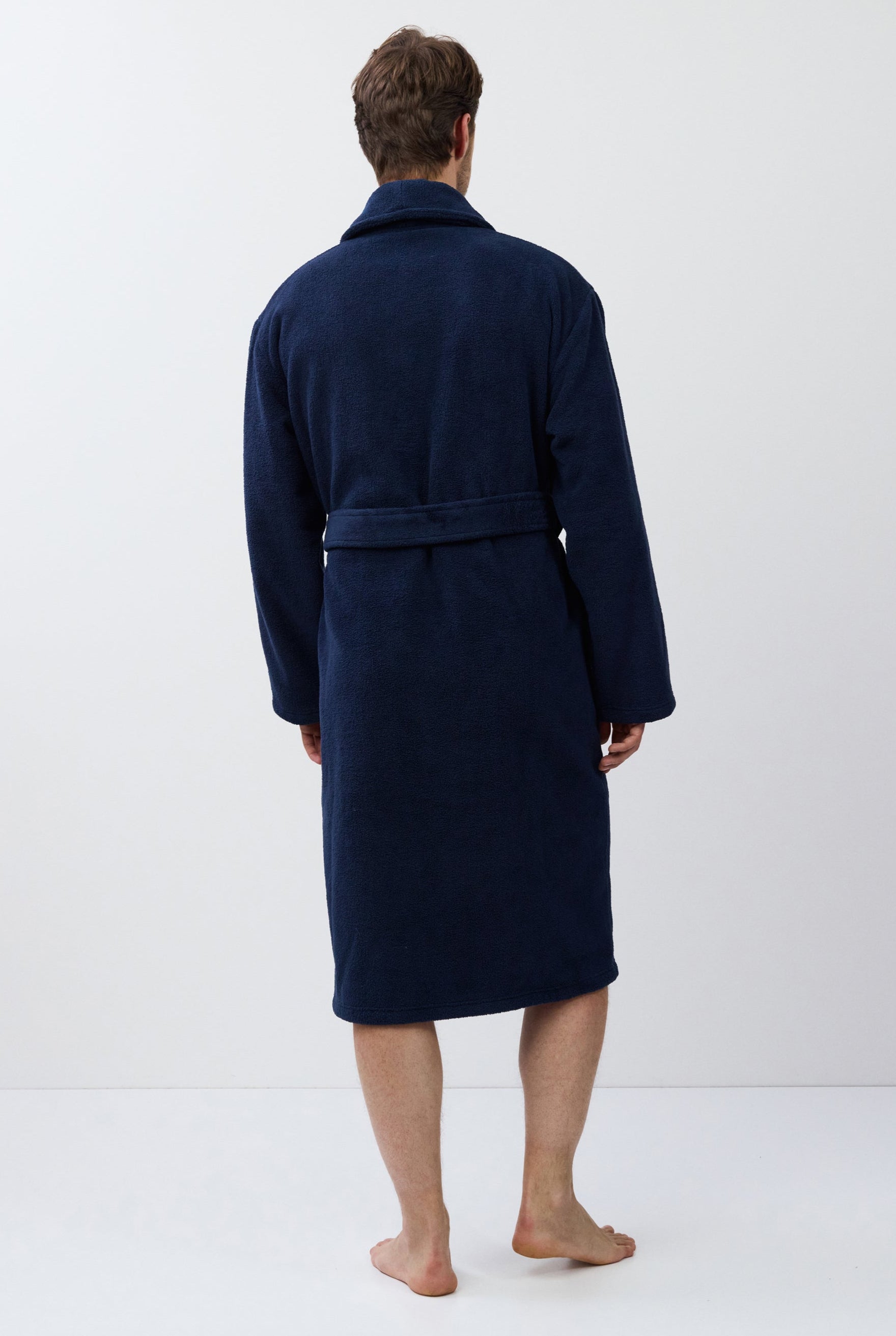 Man wearing a navy blue robe on a white background