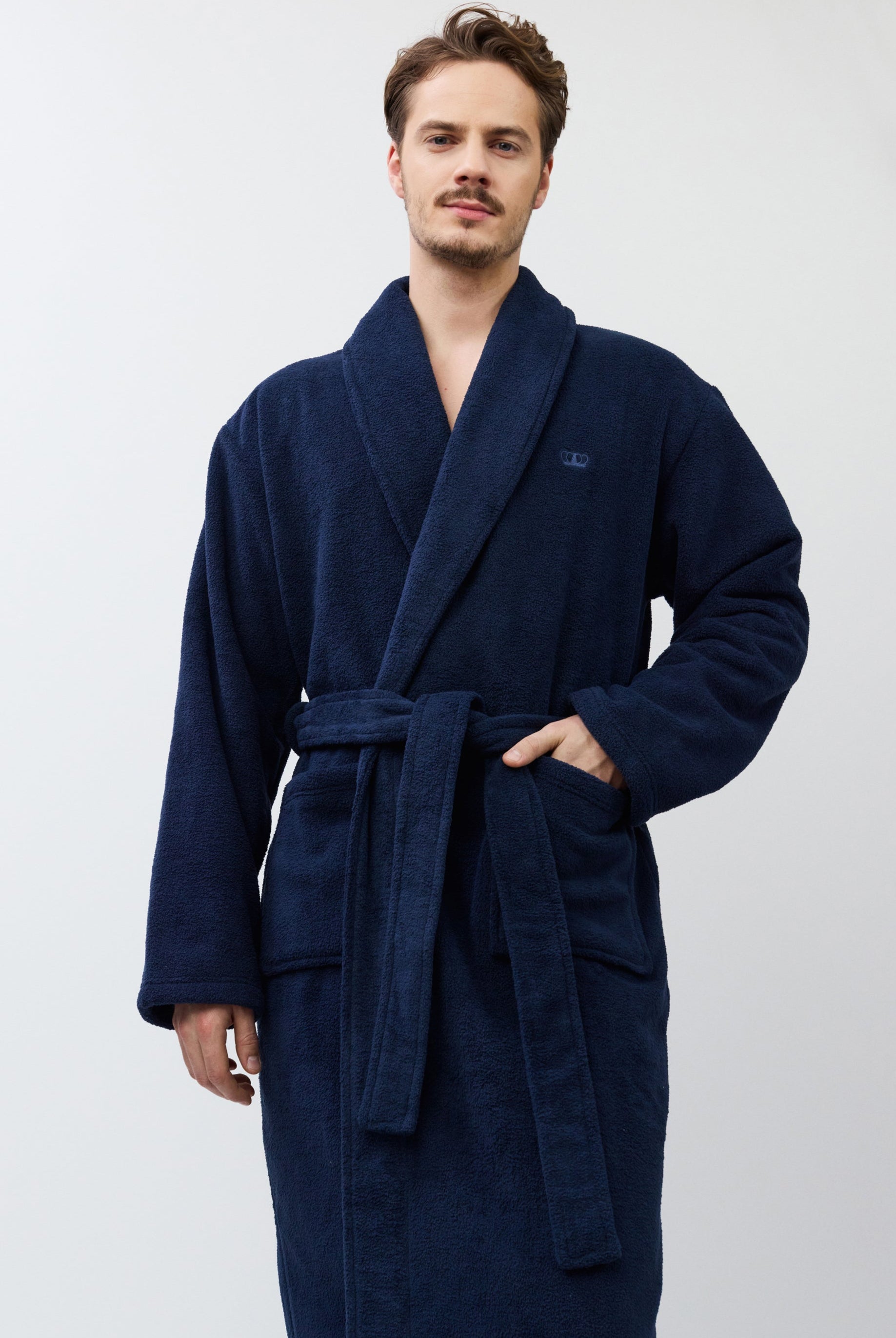 Man wearing a navy blue robe against a white background