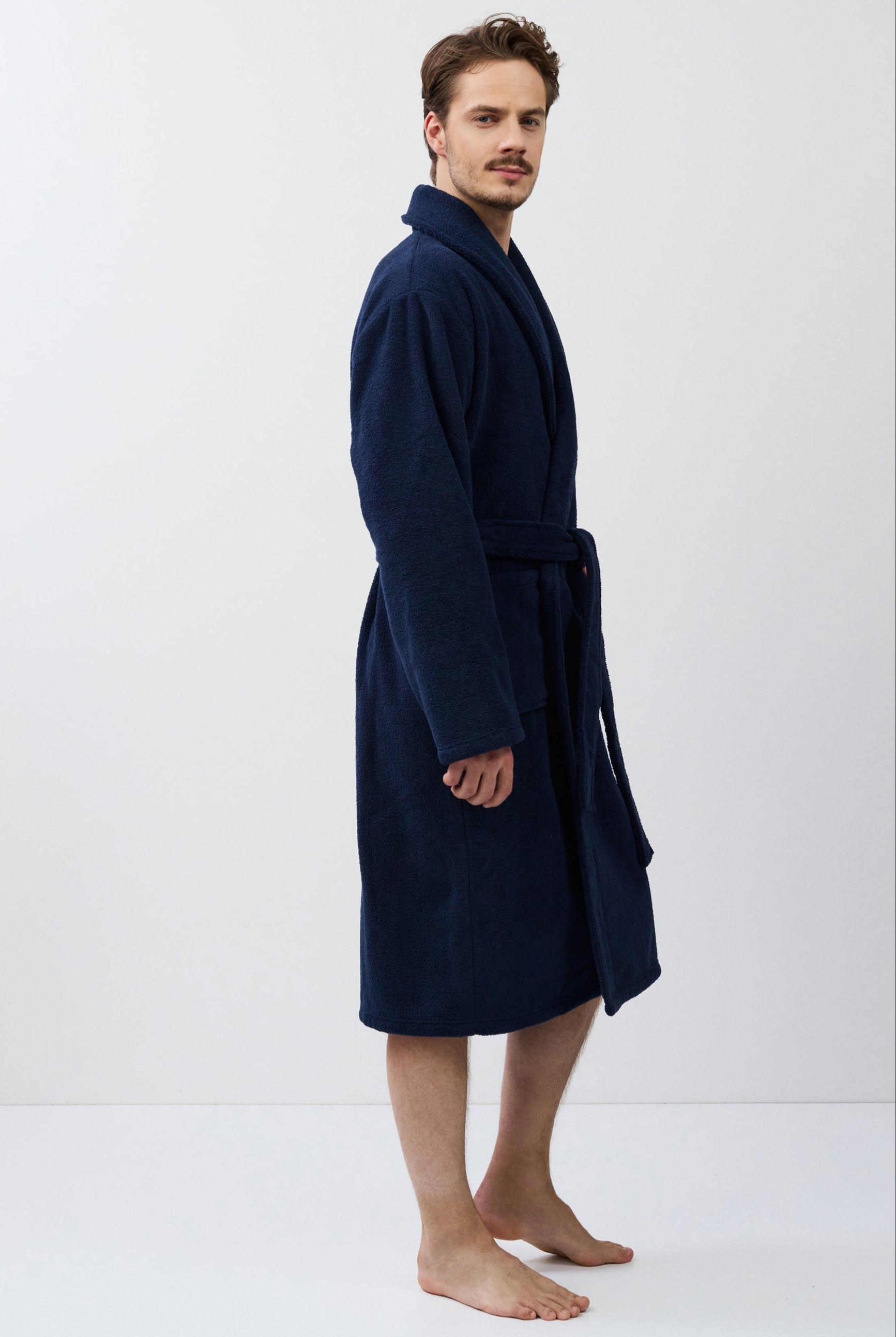 Man wearing a navy blue robe on a white background