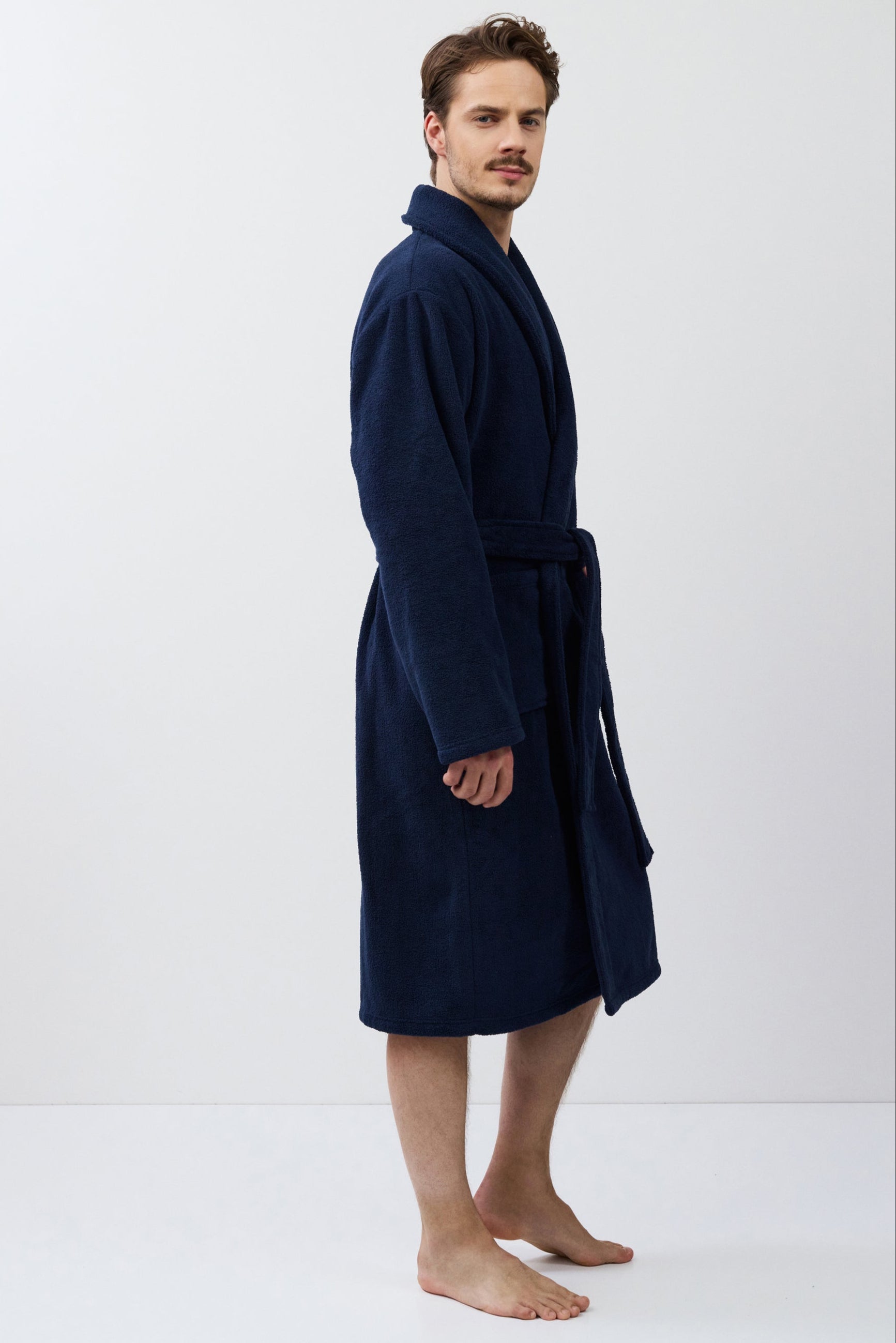 Man wearing a navy blue robe on a white background