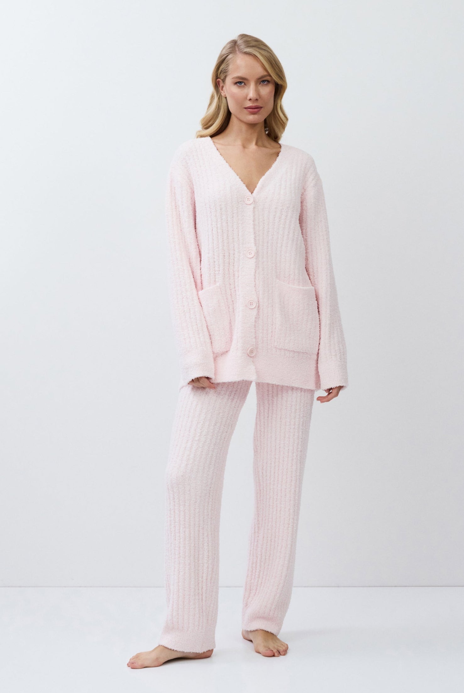 Woman wearing a pink set on a white background