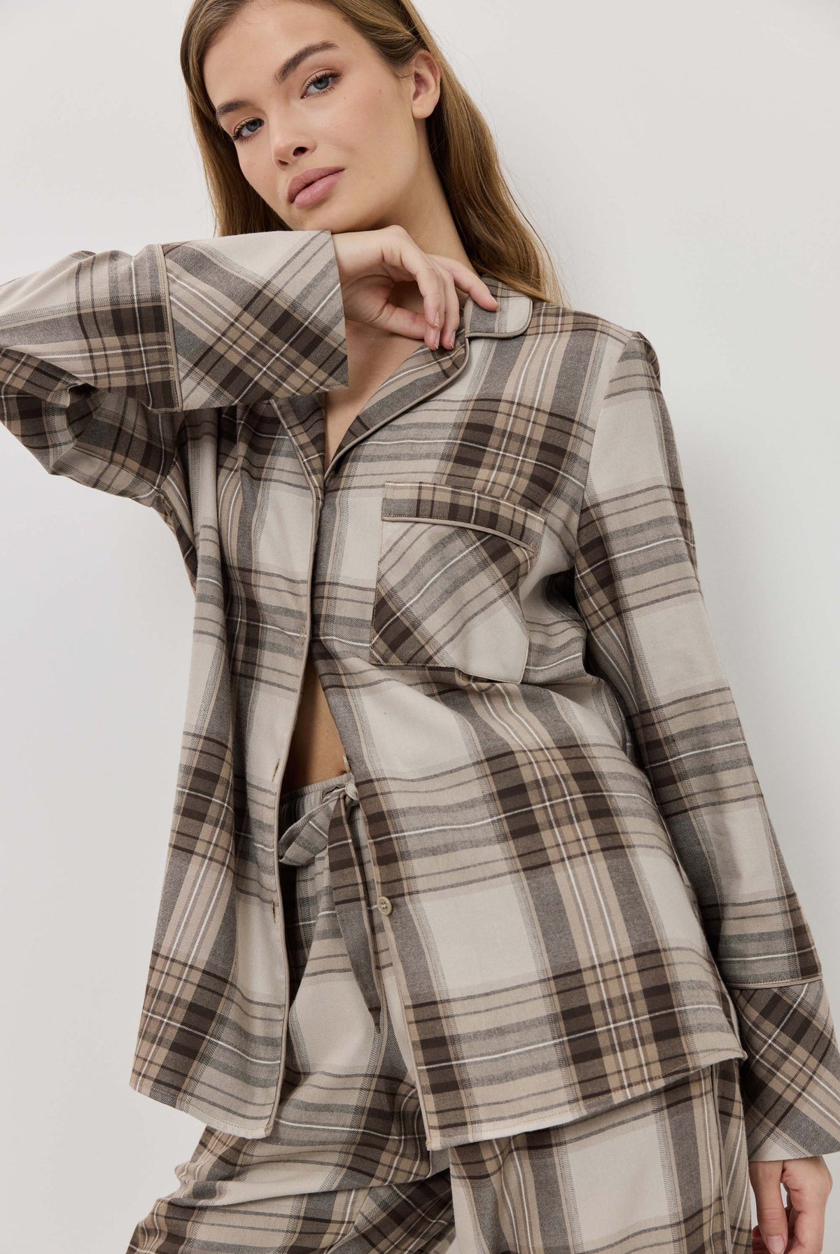 Woman wearing a plaid outfit on a white background