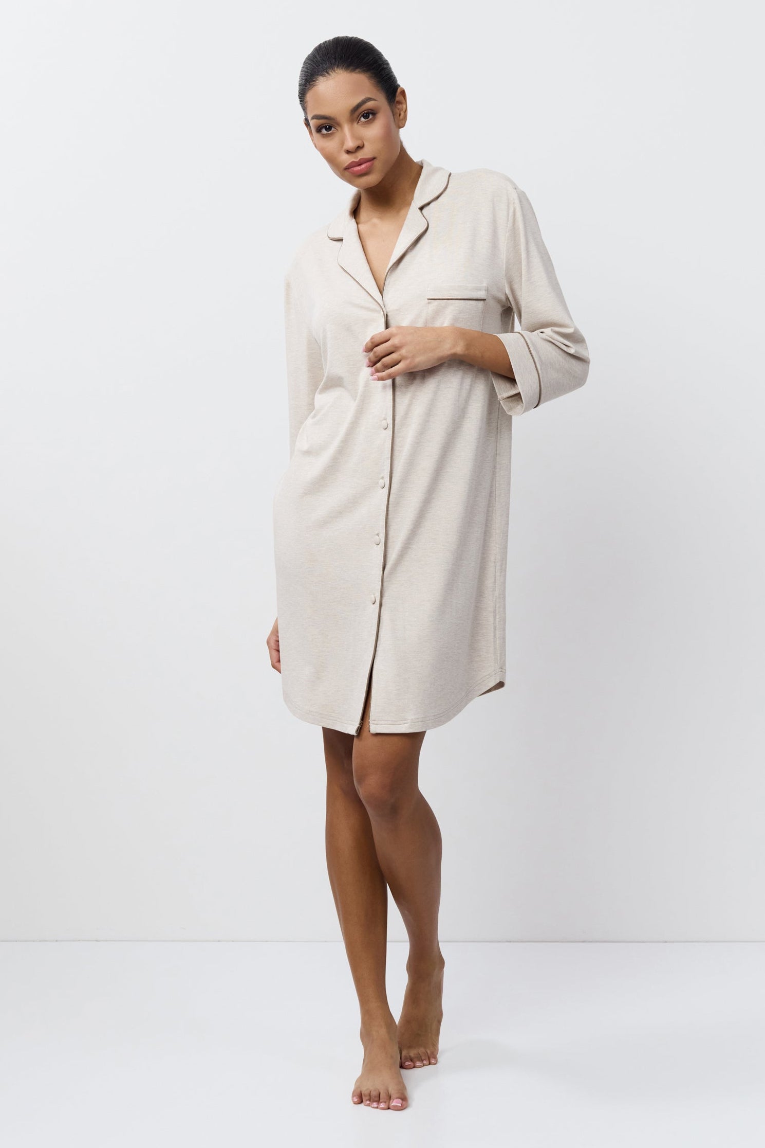 Woman wearing a beige nightdress against a white background