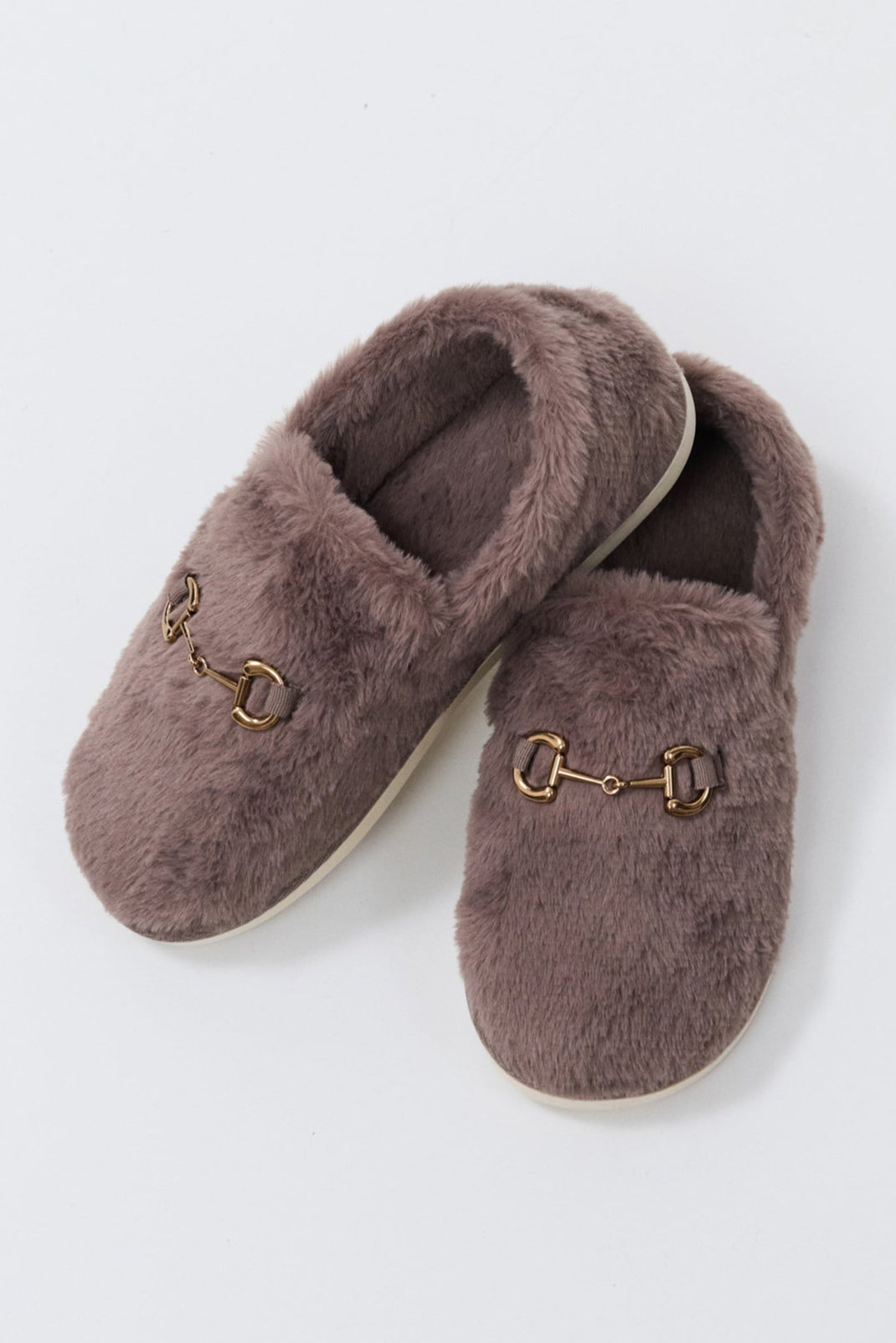 Pair of brown fuzzy slippers on a light gray background