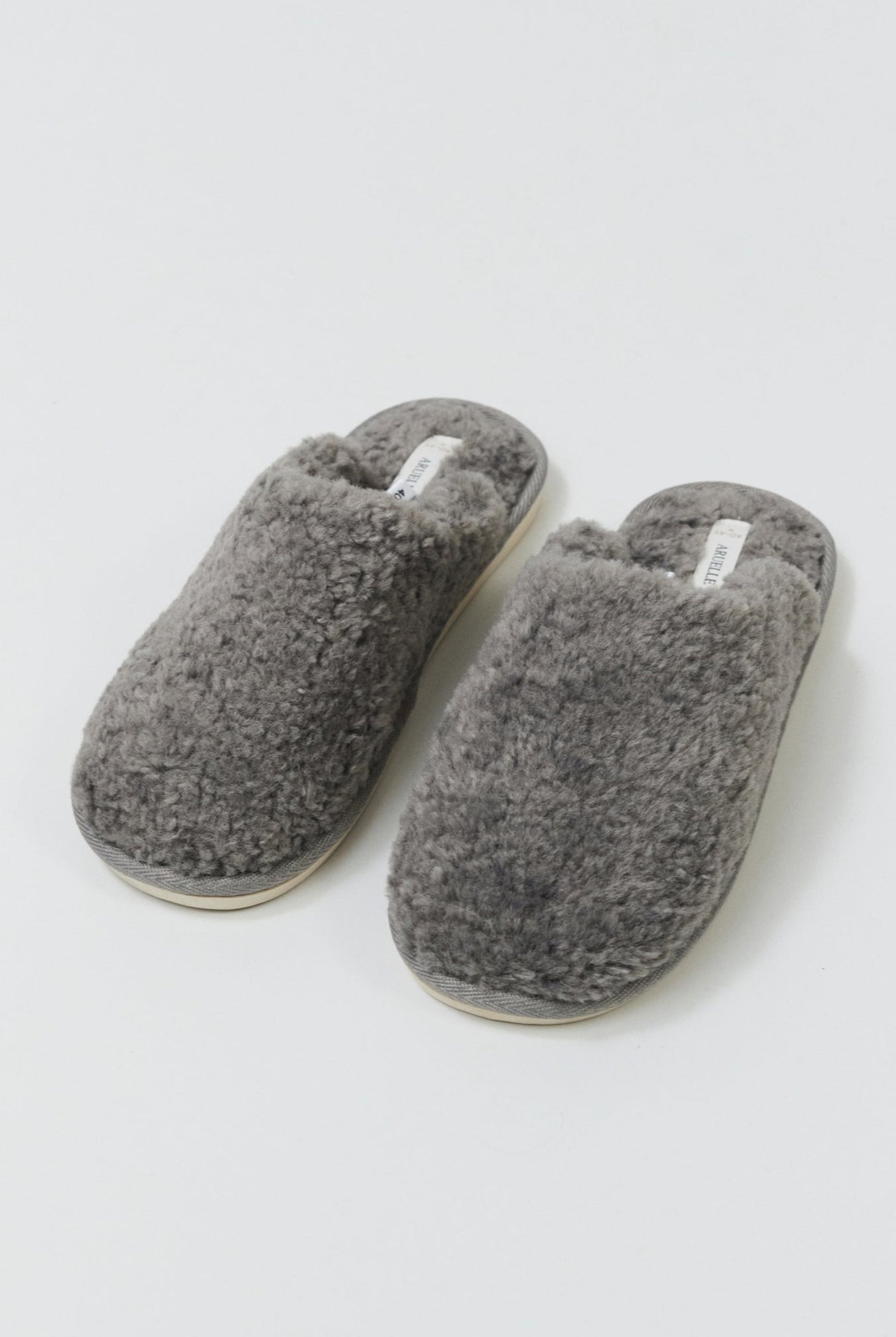 Pair of gray slippers on a white background