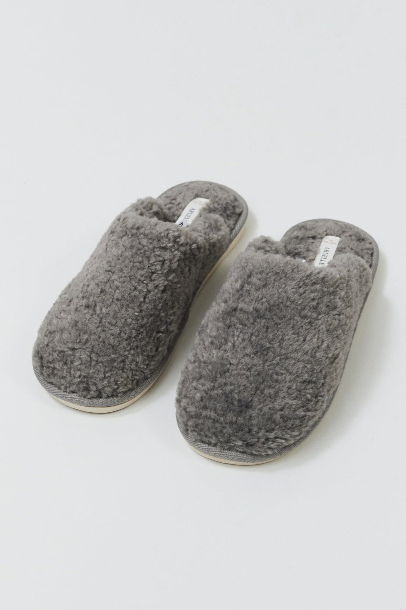 Pair of gray slippers on a white background