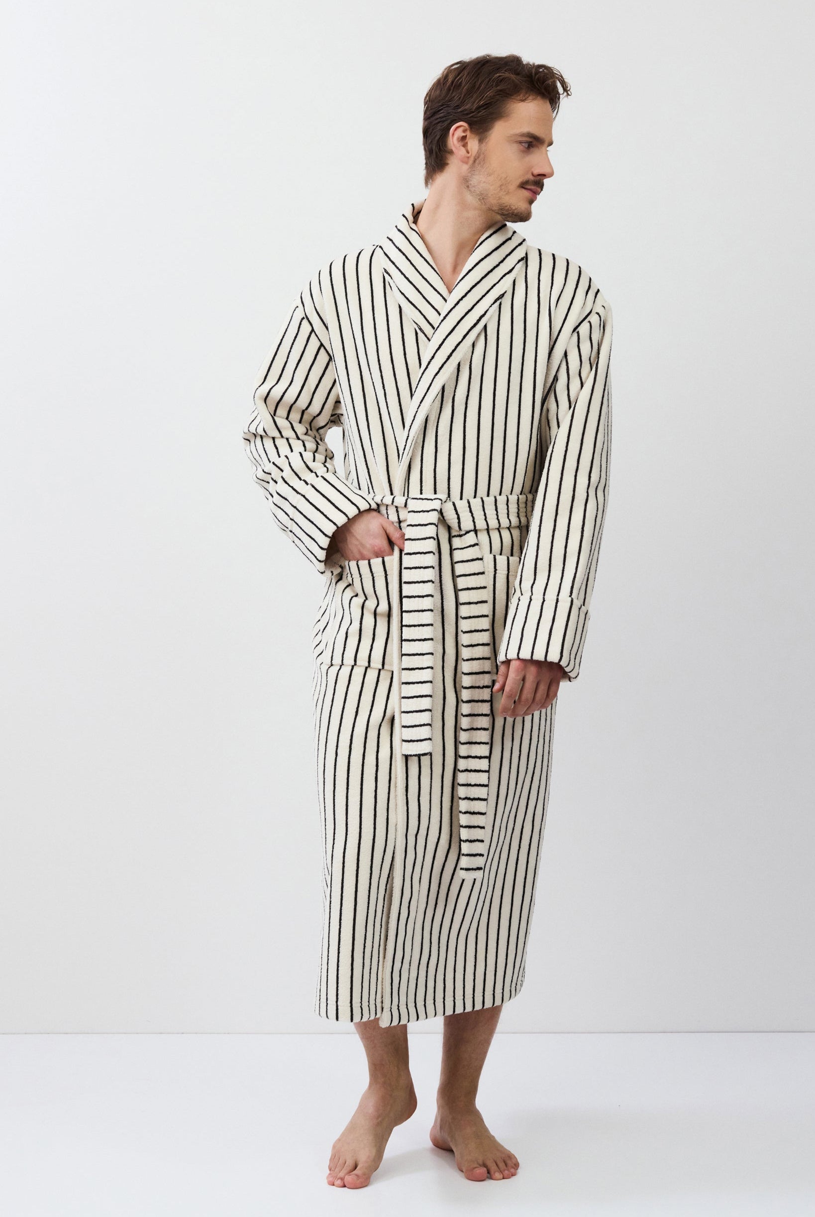 Man wearing a striped bathrobe on a white background