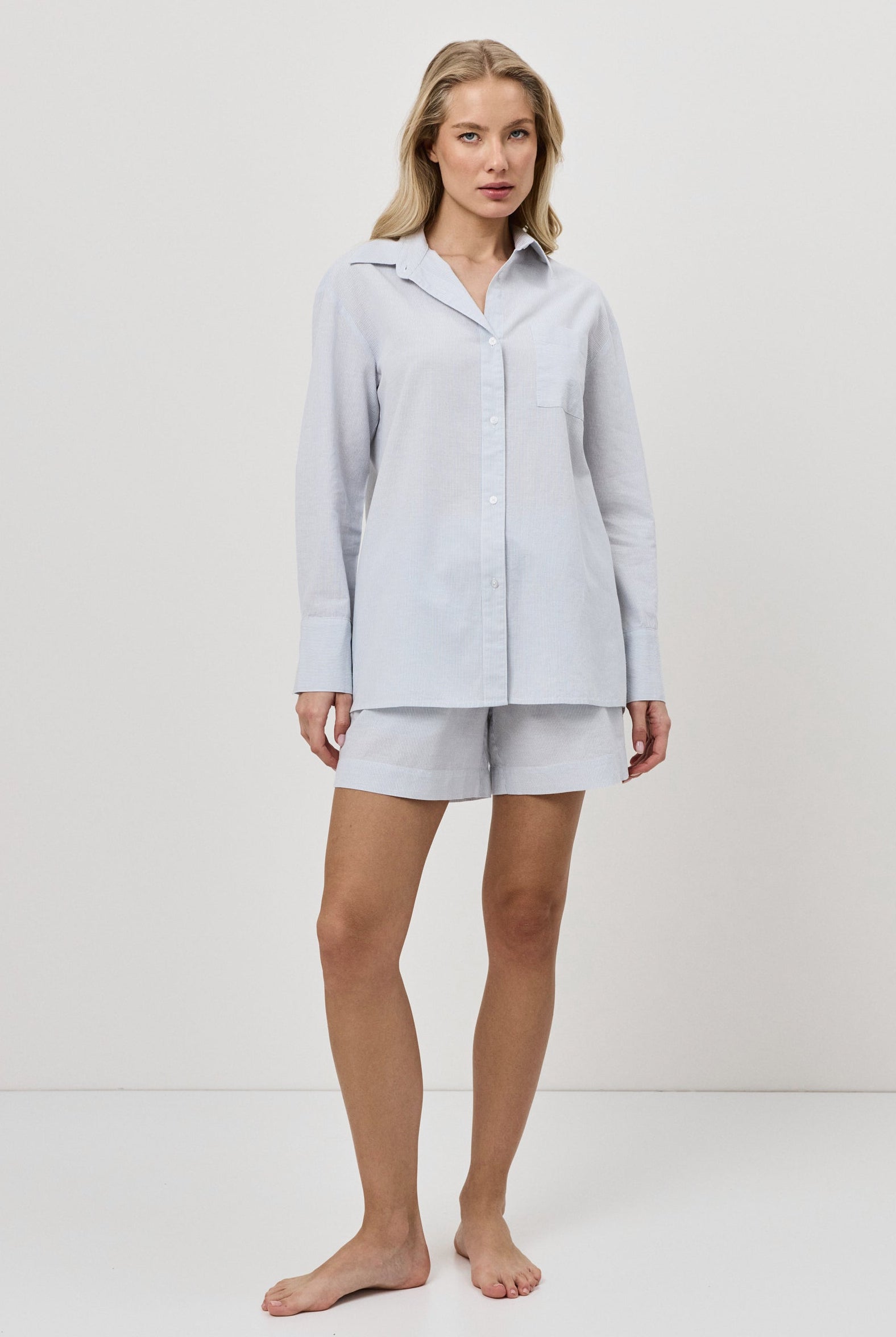 Woman wearing a blue resort wear set on a white background