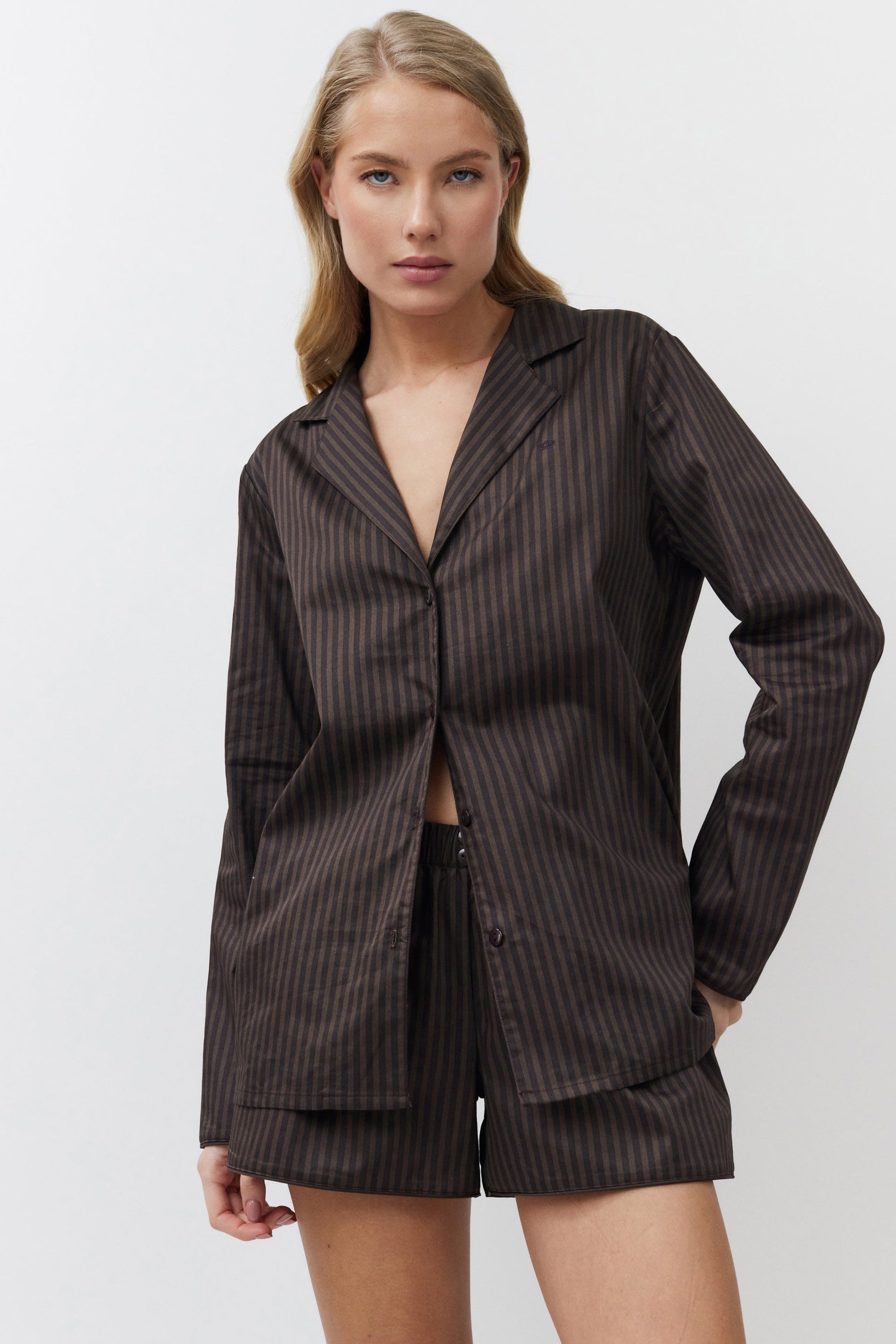 Woman wearing a brown set on a white background