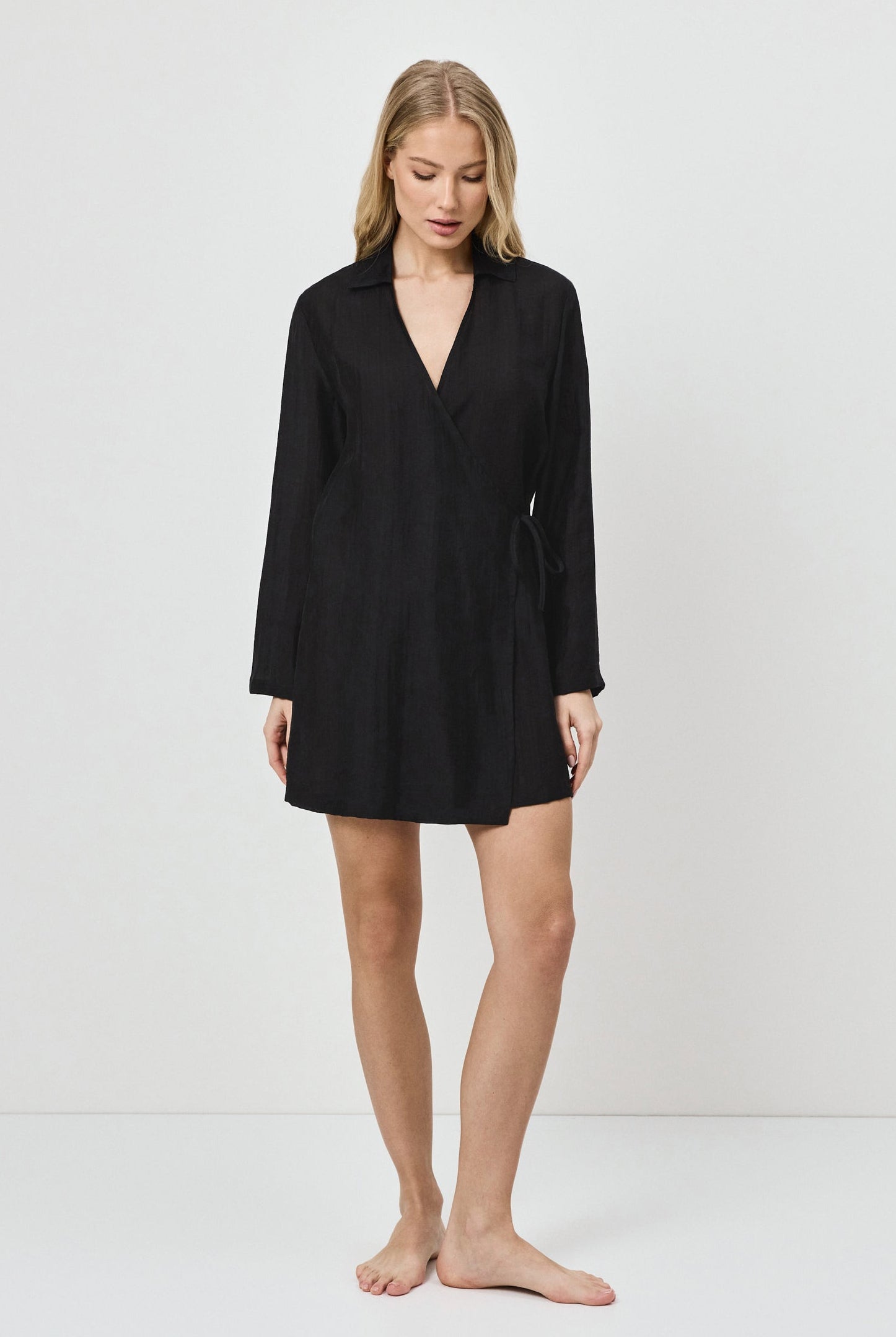 Woman wearing a black dress against a white background