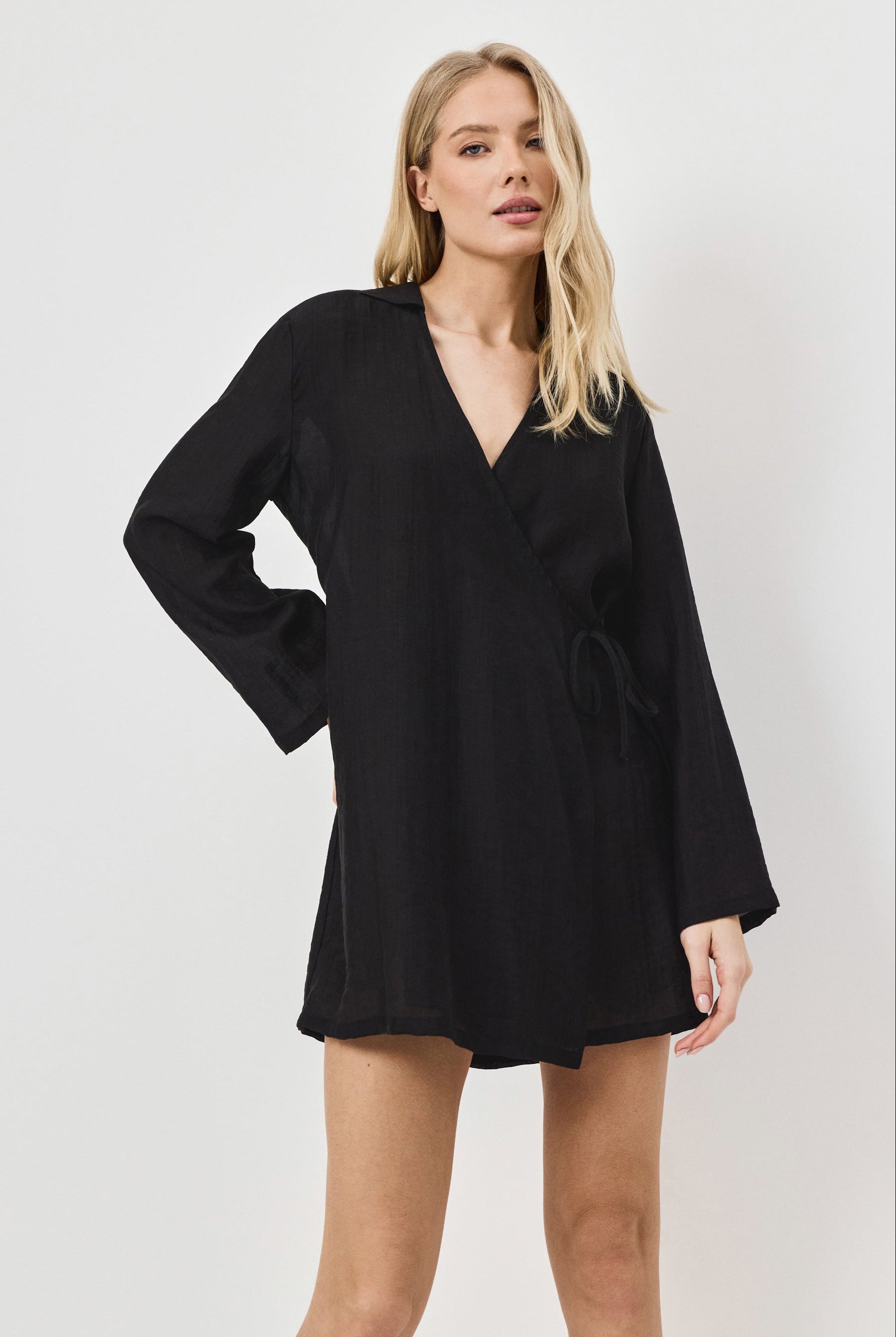 Woman wearing a black dress against a white background