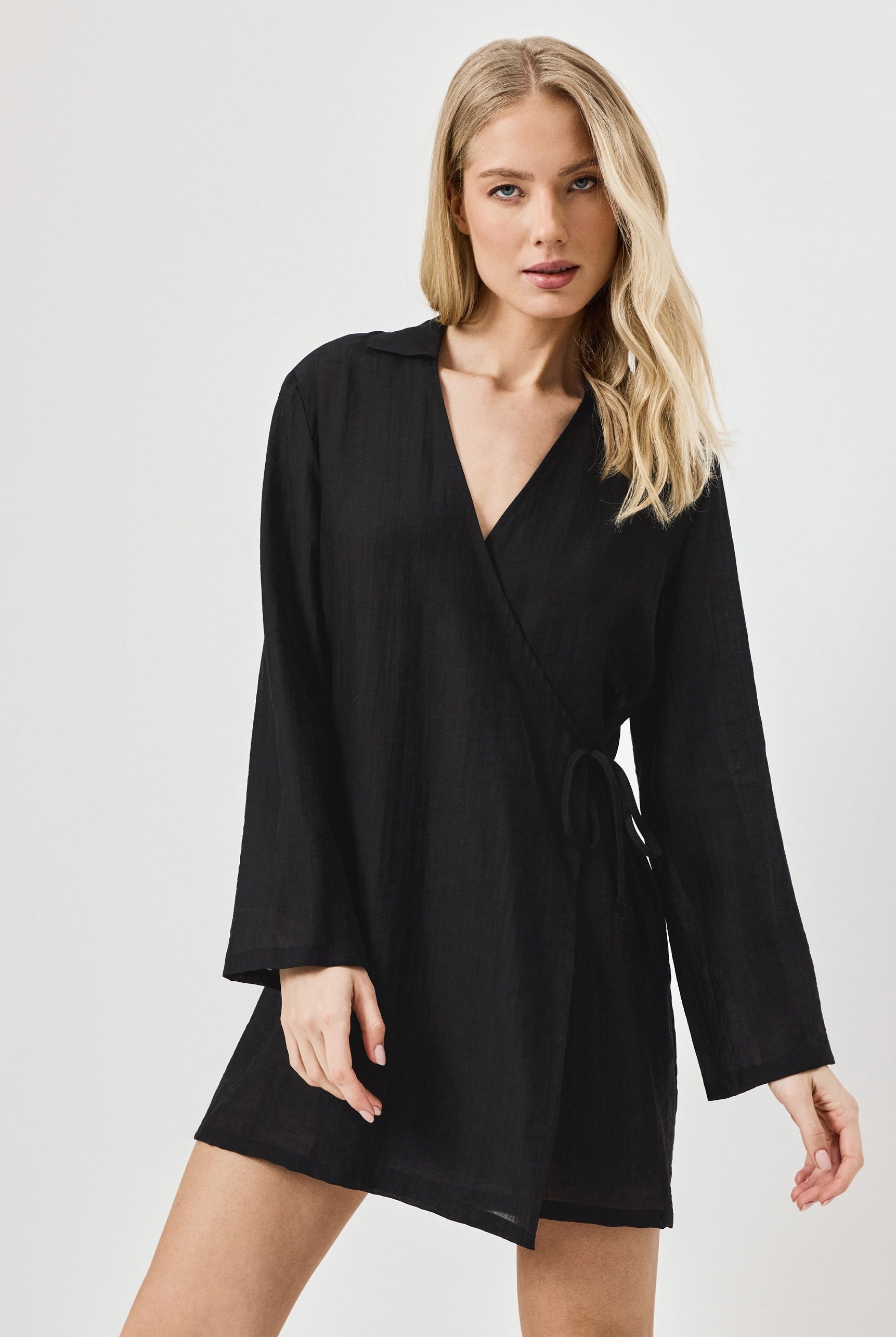 Woman wearing a black dress against a white background