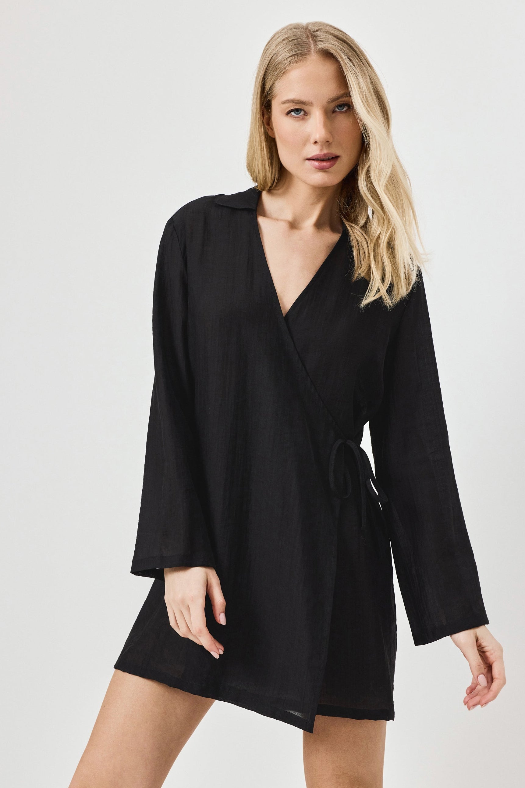 Woman wearing a black dress against a white background