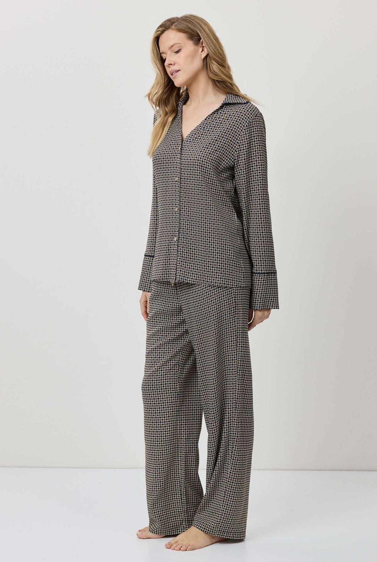 Woman wearing a checkered pajama set on a white background