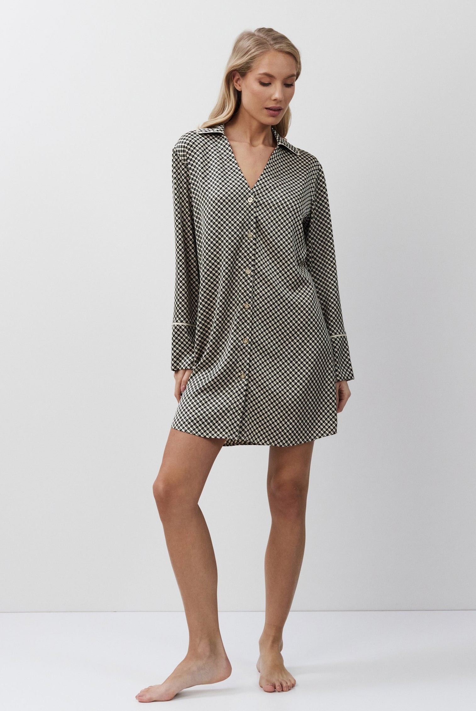 Woman wearing a patterned nightshirt on a white background