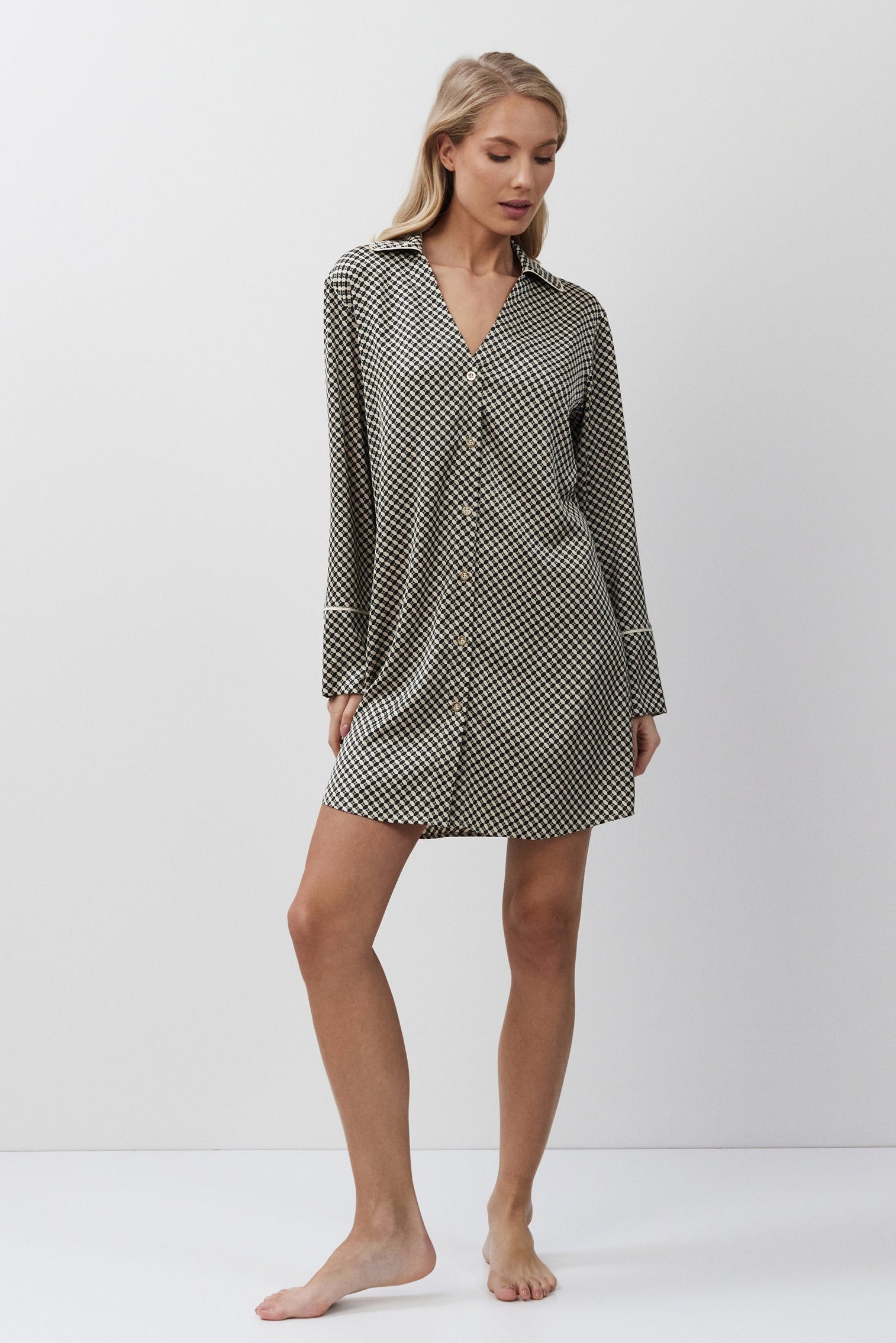 Woman wearing a patterned nightshirt on a white background