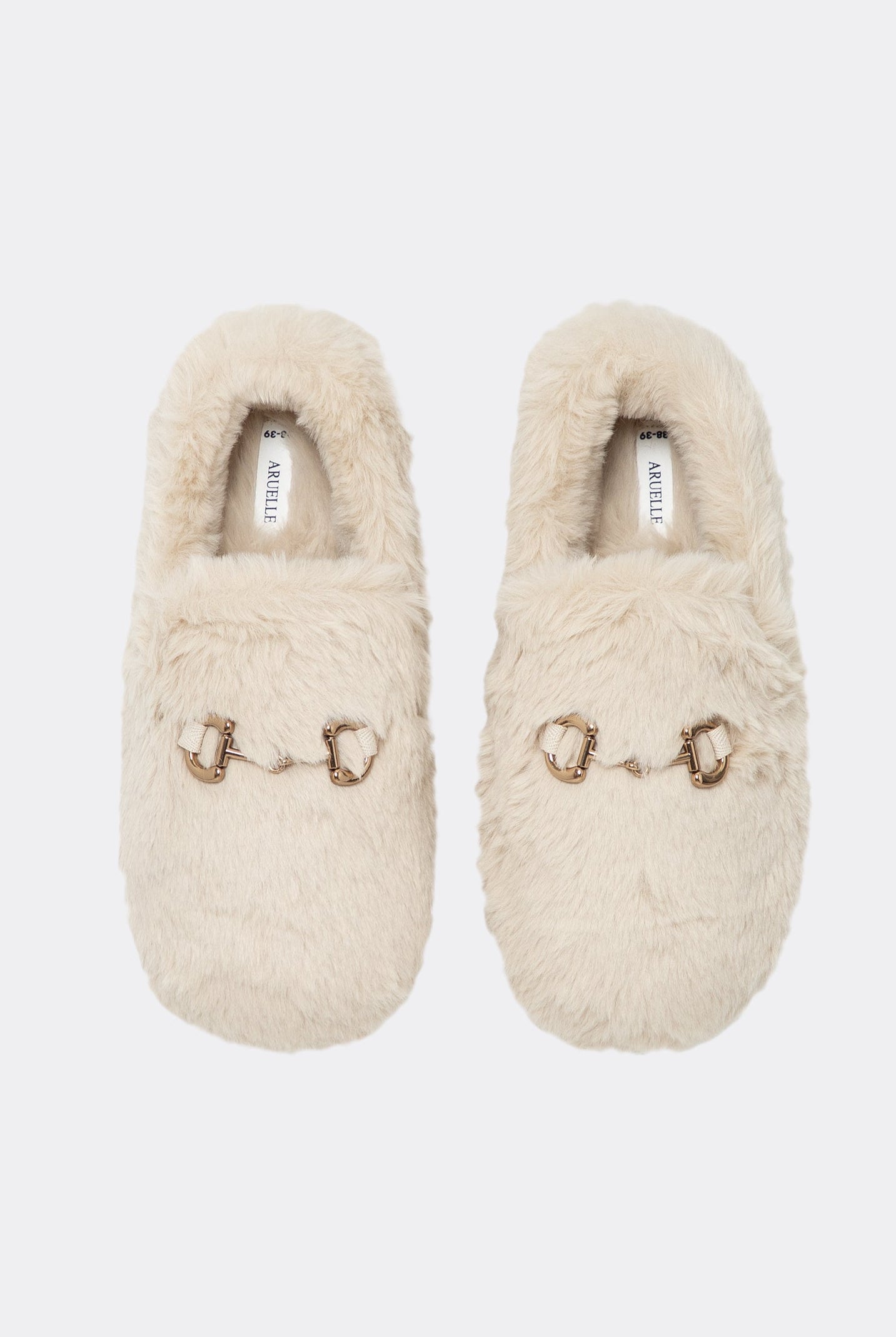 Pair of beige slippers with decorative elements on a white background