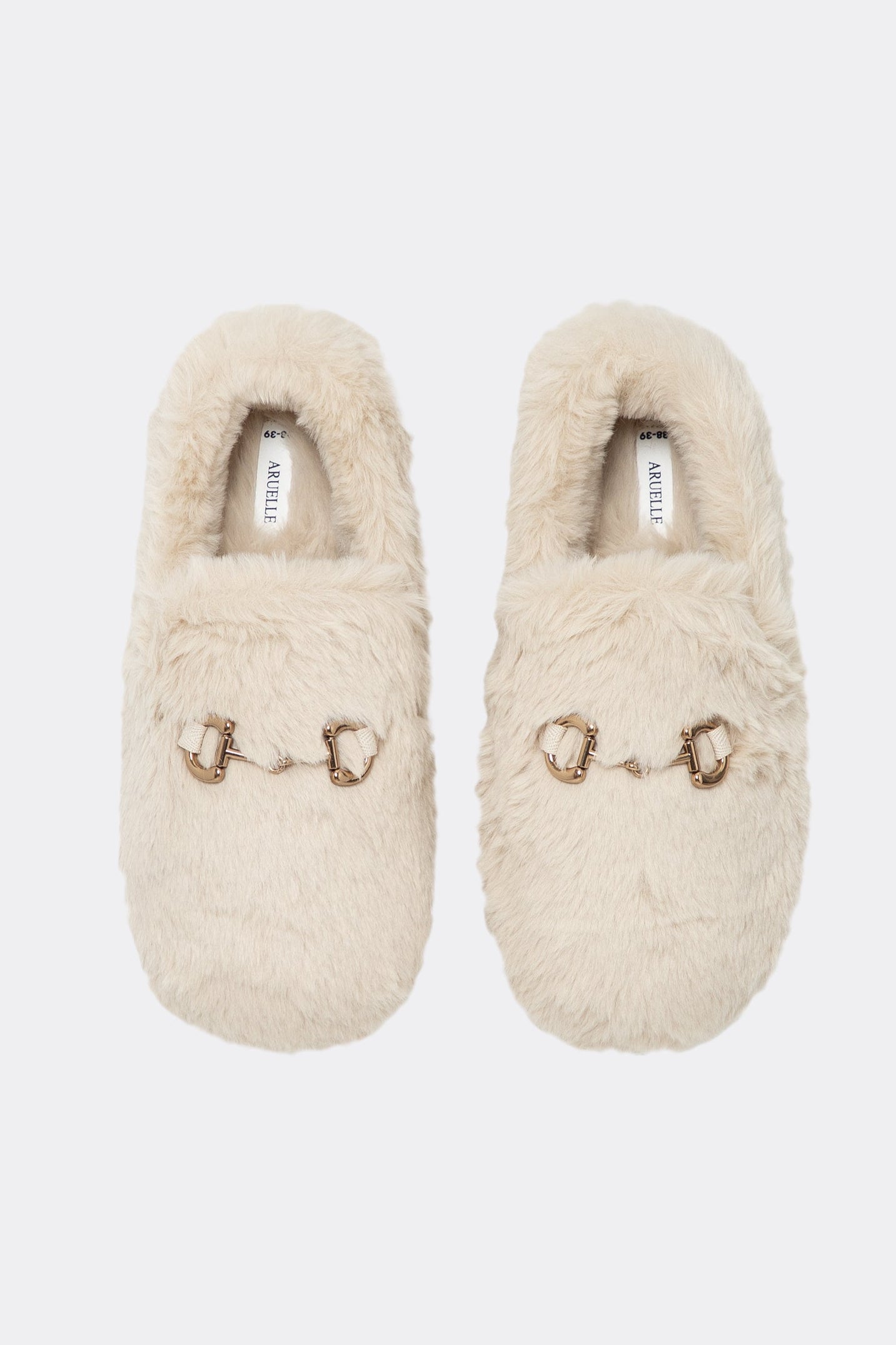 Pair of beige slippers with decorative elements on a white background