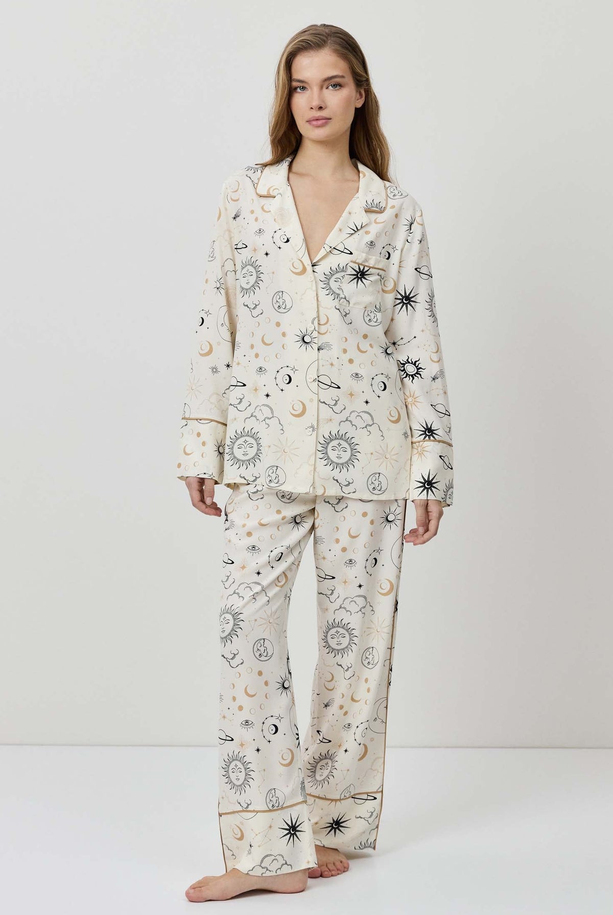 Woman wearing a floral pajama set on a white background