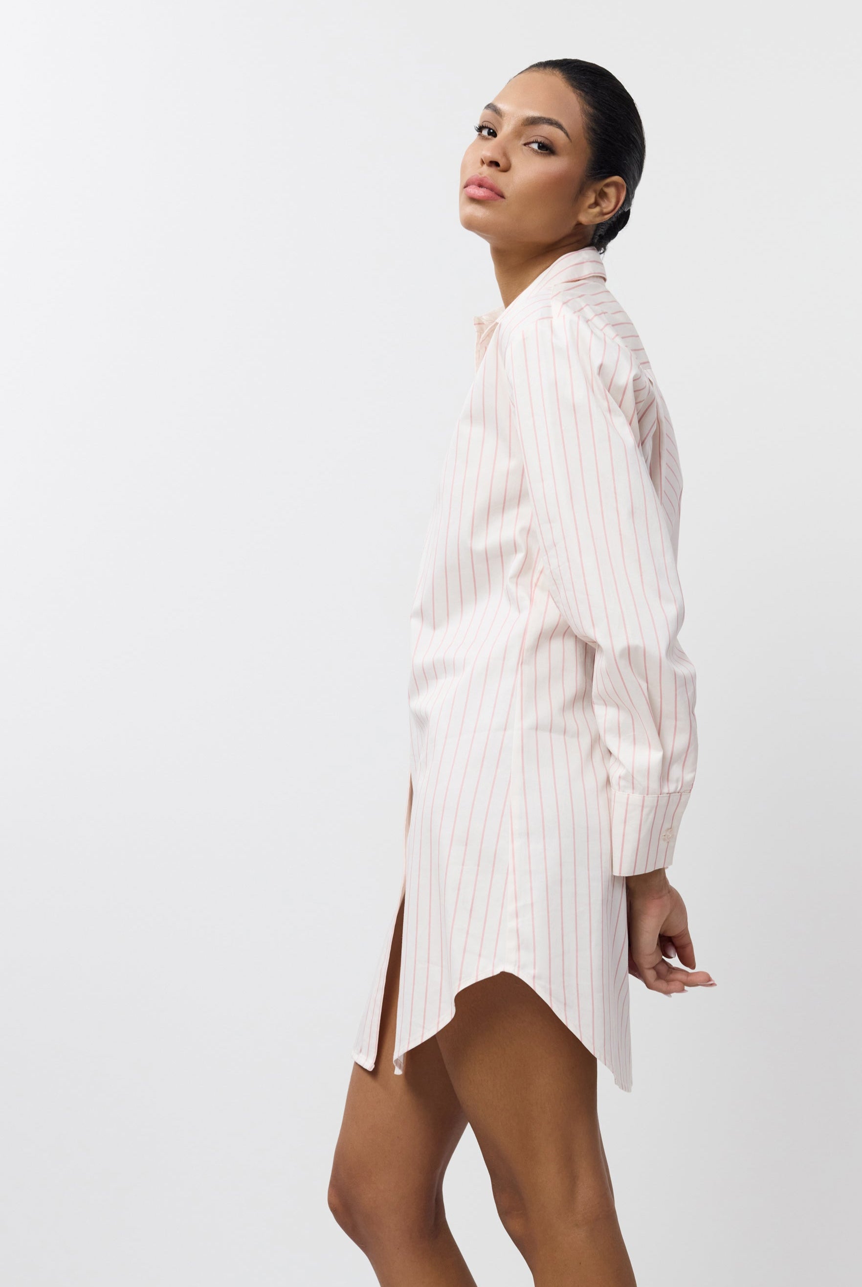 Woman wearing a white striped shirt on a white background