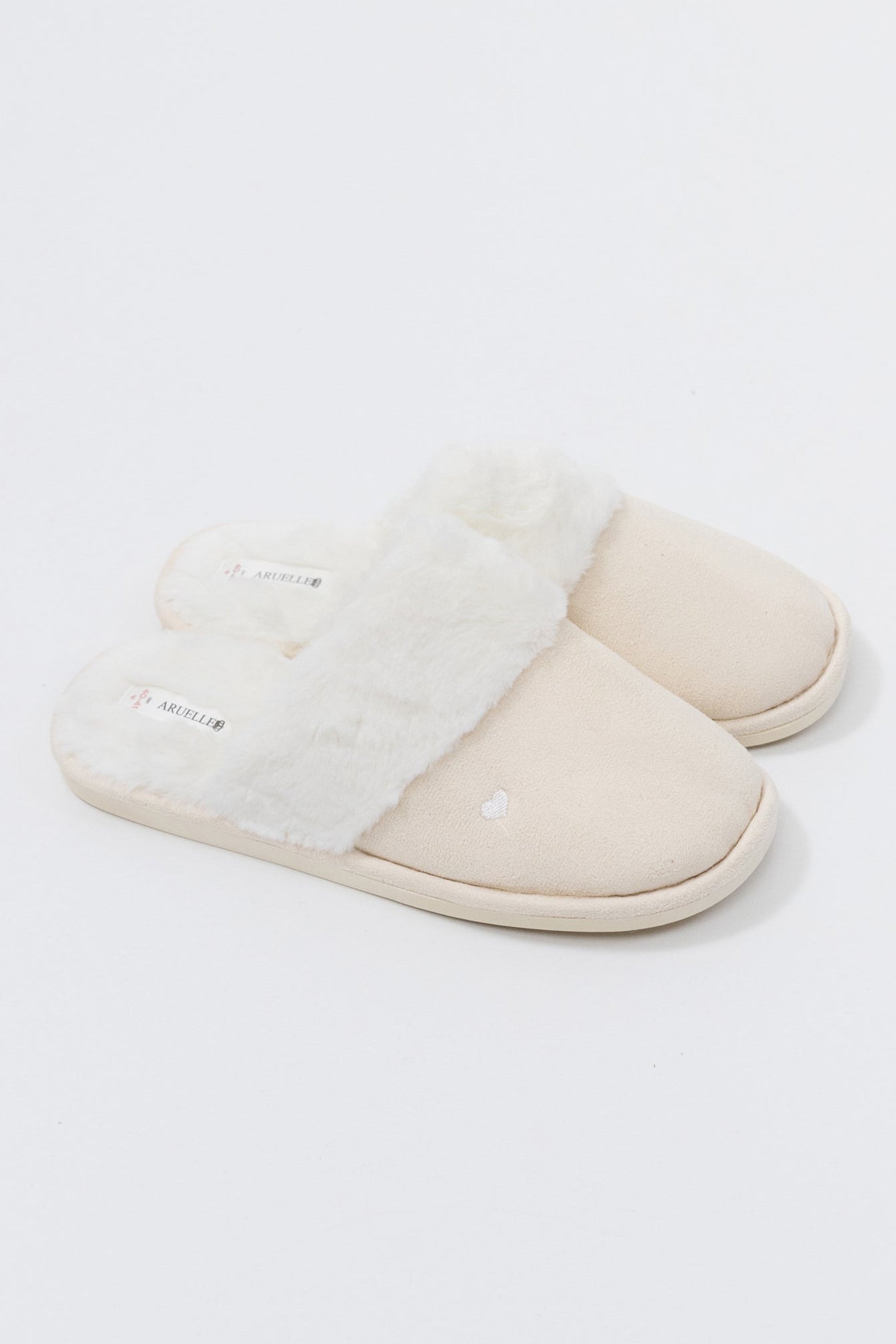 Pair of white slippers on a light gray background