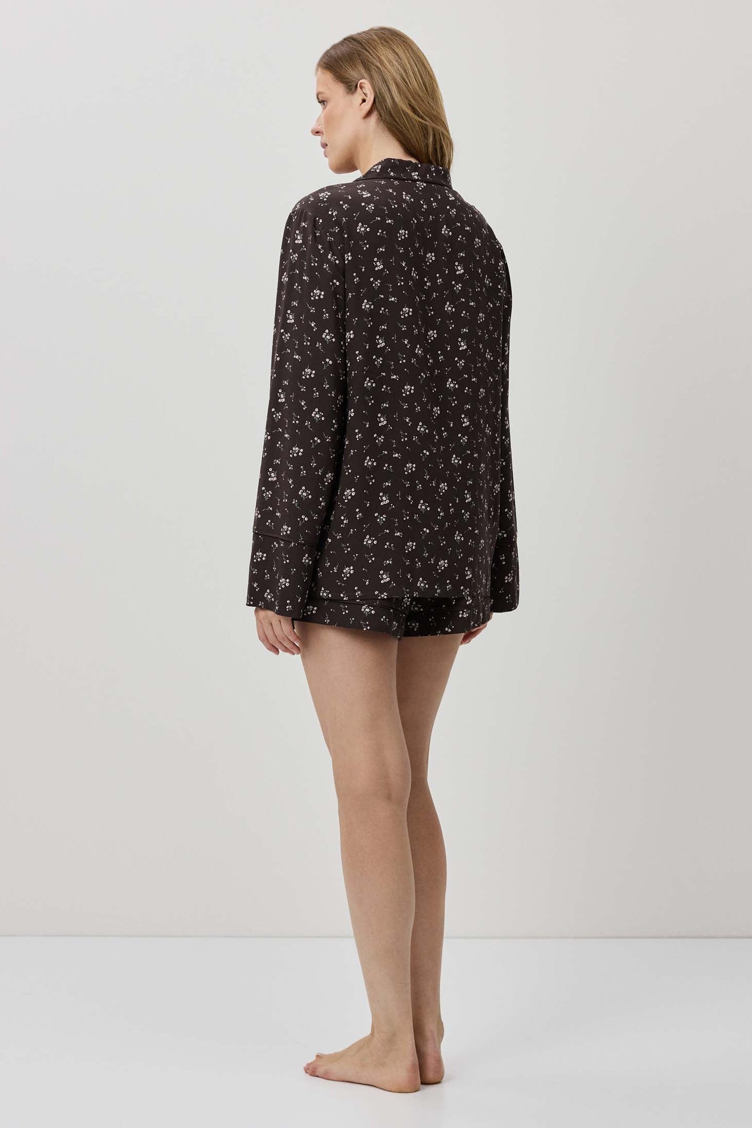 Woman wearing a patterned shirt on a white background