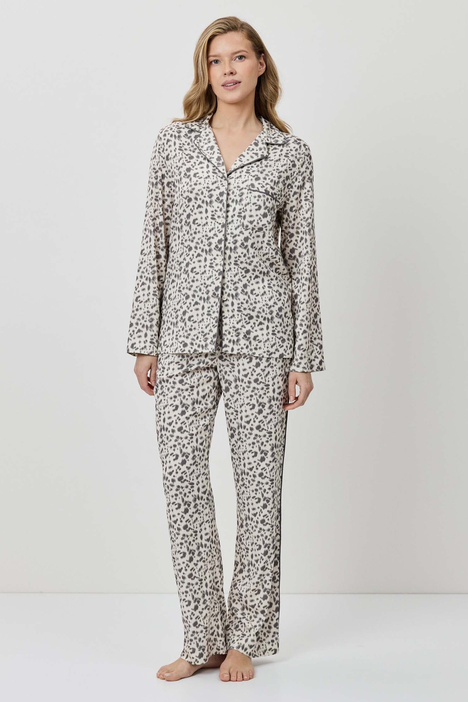 Woman wearing a patterned pajama set on a white background