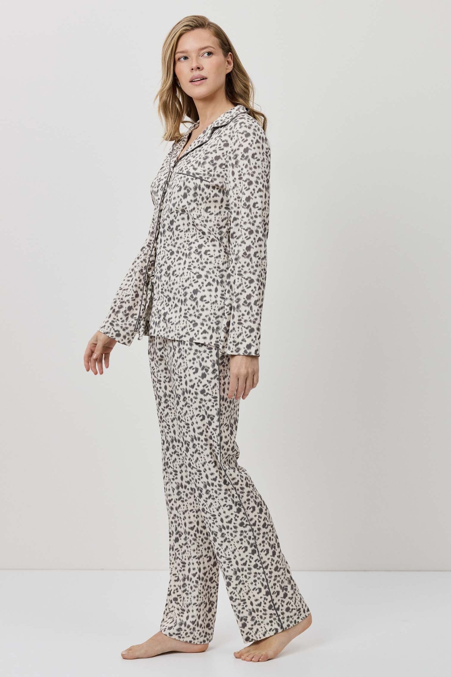 Woman wearing a floral pajama set on a white background
